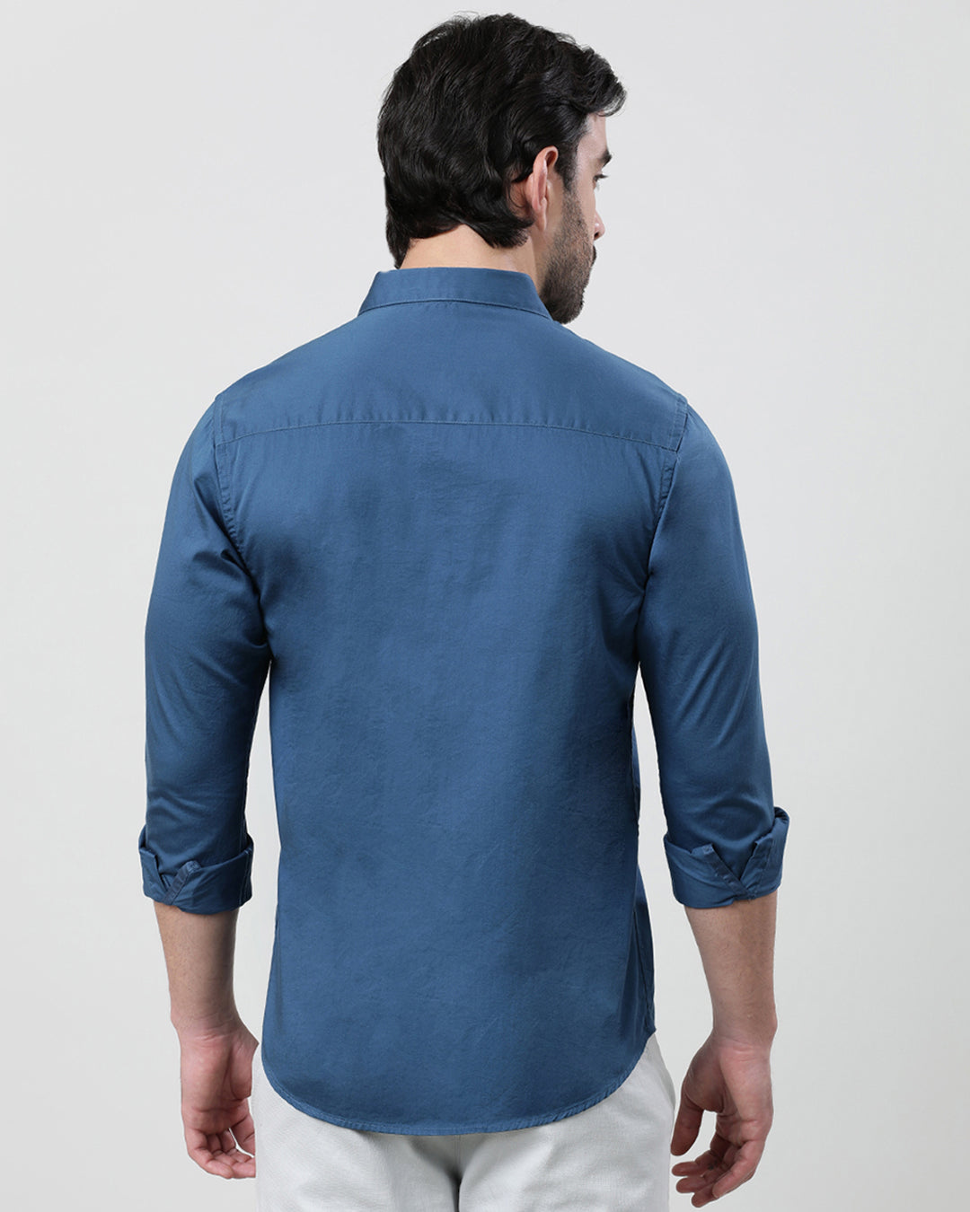 Man wearing a blue royal blue solid full sleeve 100% cotton shirt with casual styling on a gray background