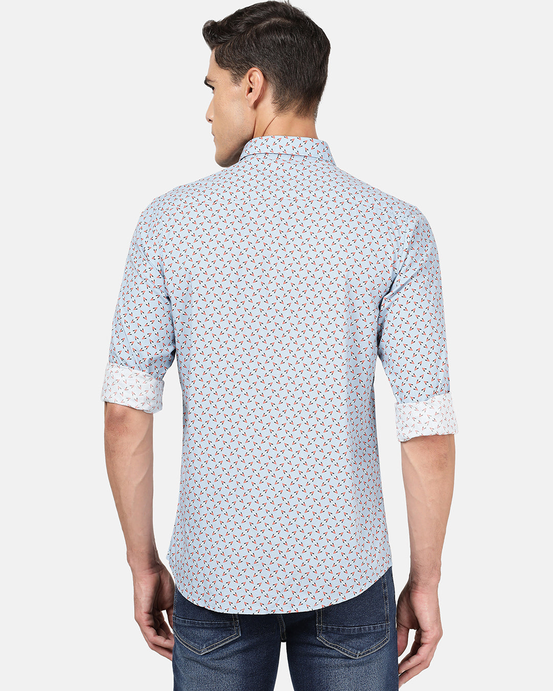 Man wearing a blue light blue printed full sleeve 100% cotton shirt on a light gray background