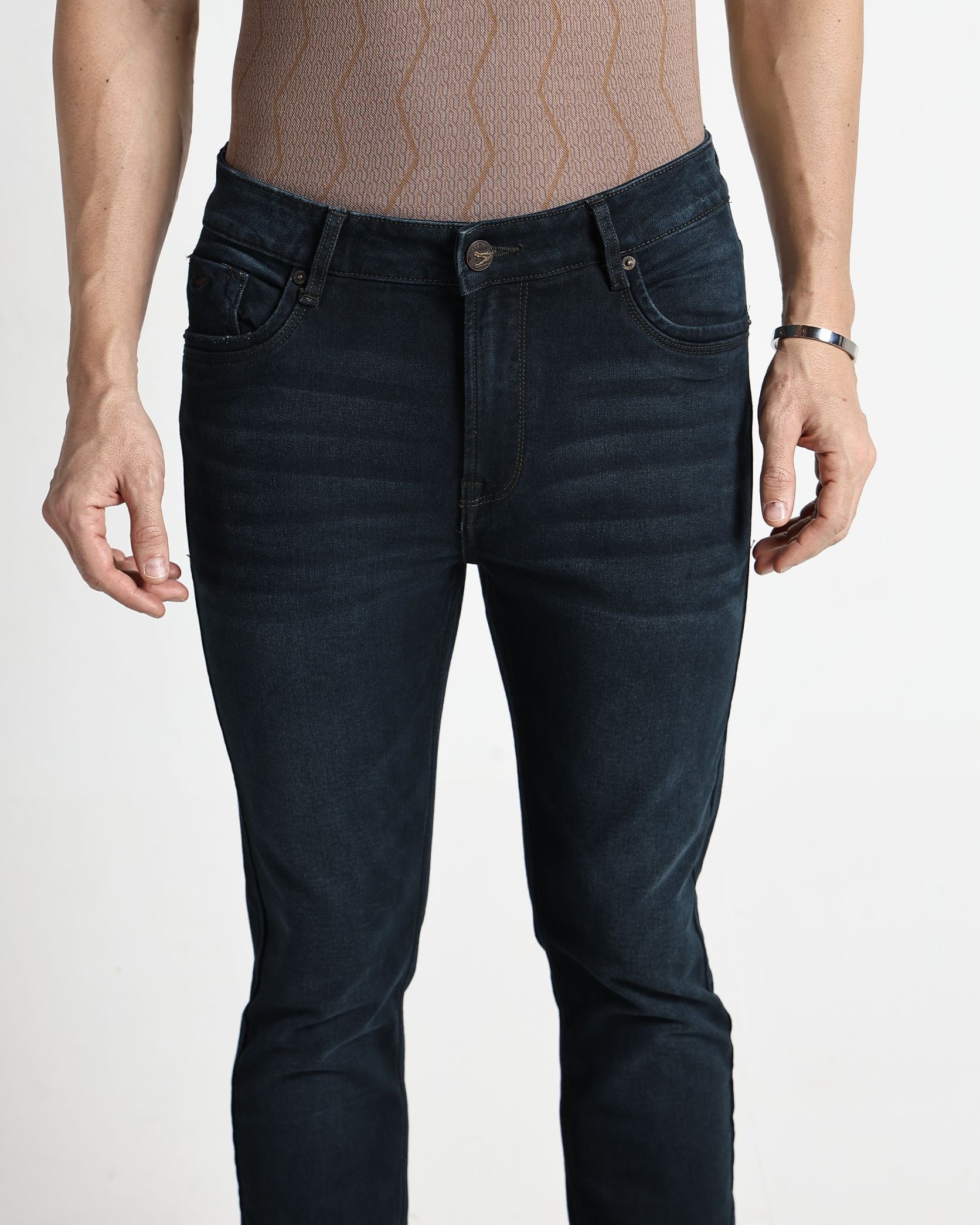 Person wearing dark blue jeans on a white background