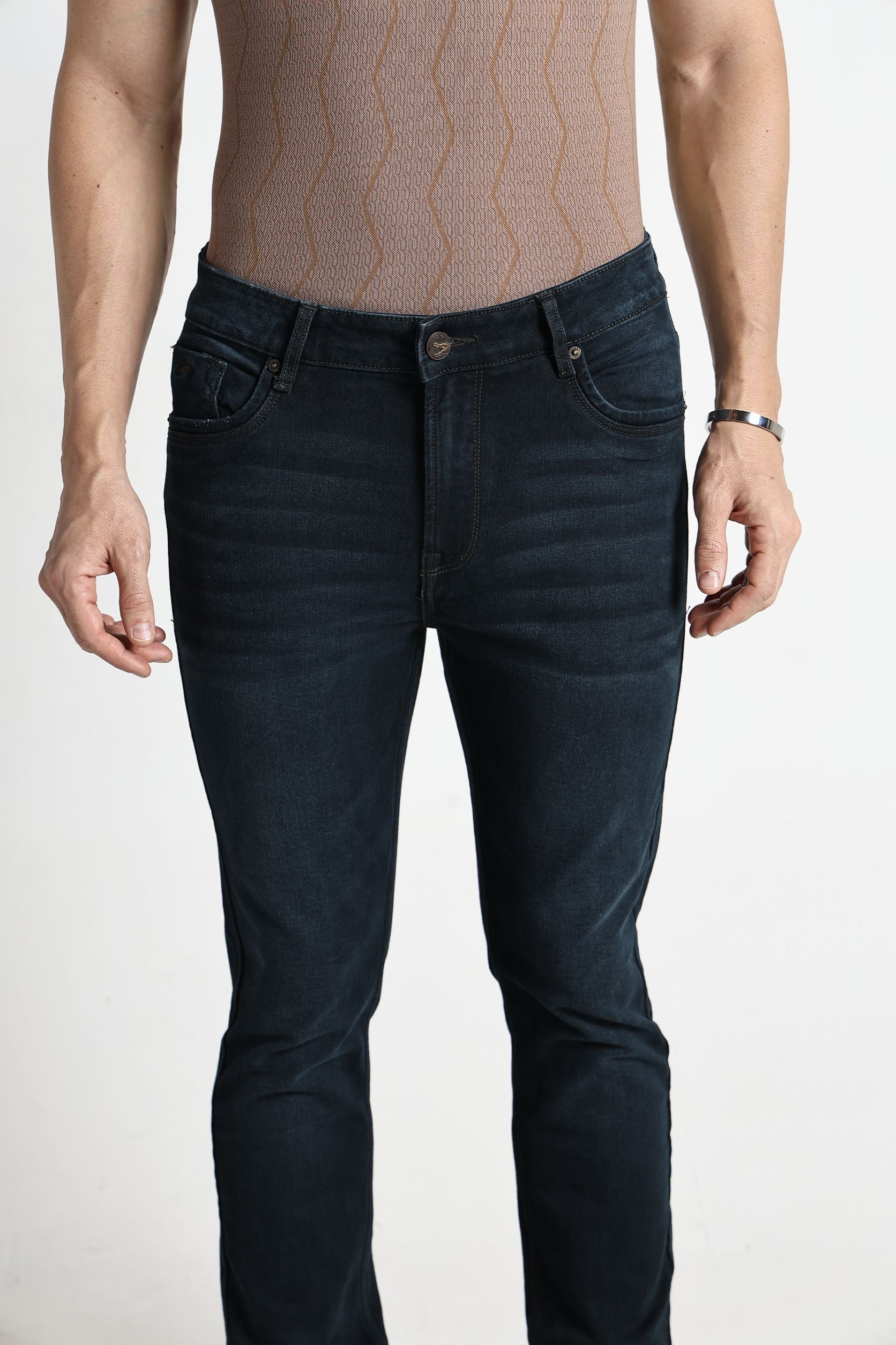 Person wearing dark blue jeans on a white background