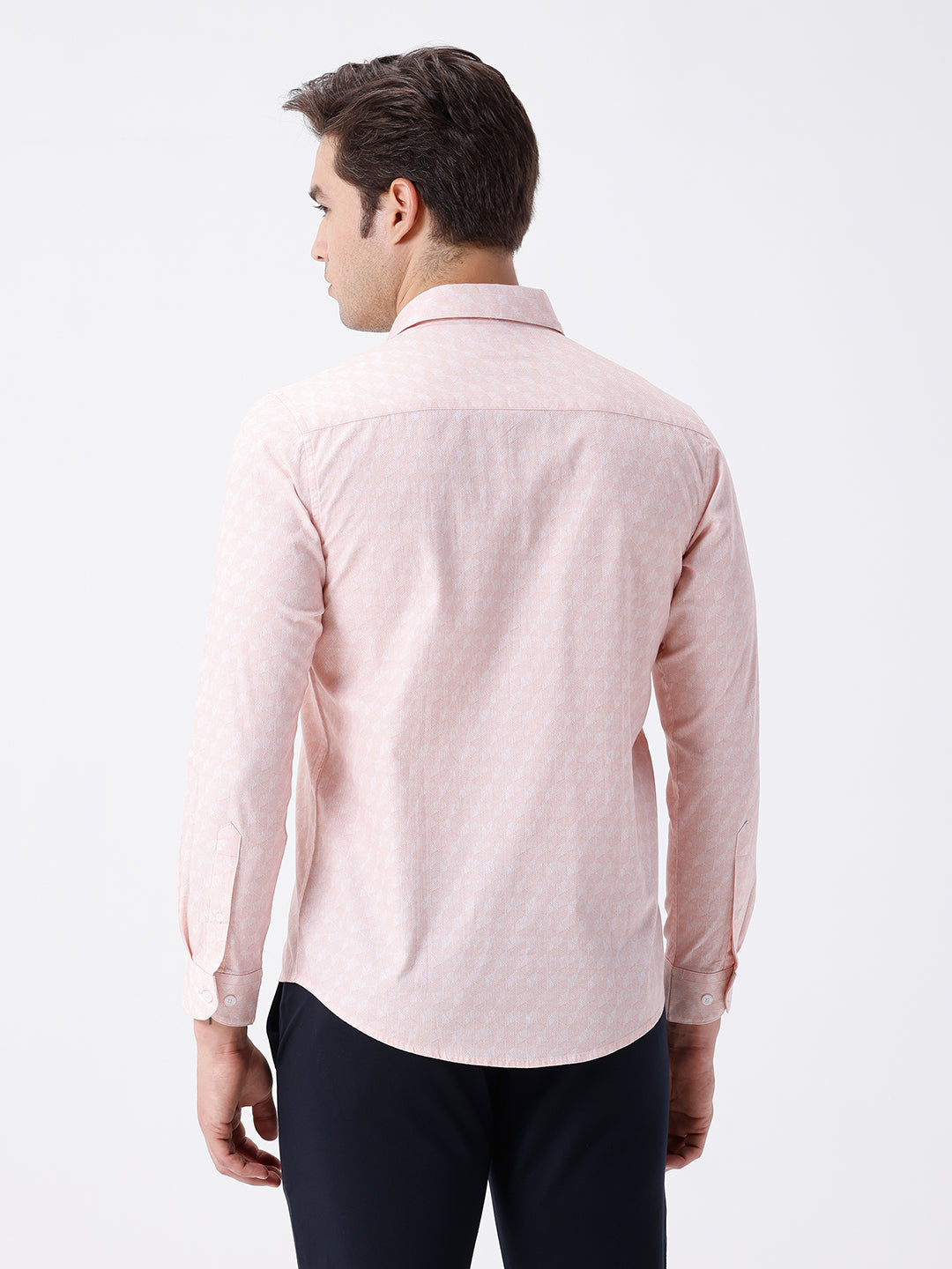 Man wearing a geomentic diamond print shirt orange on a light gray background