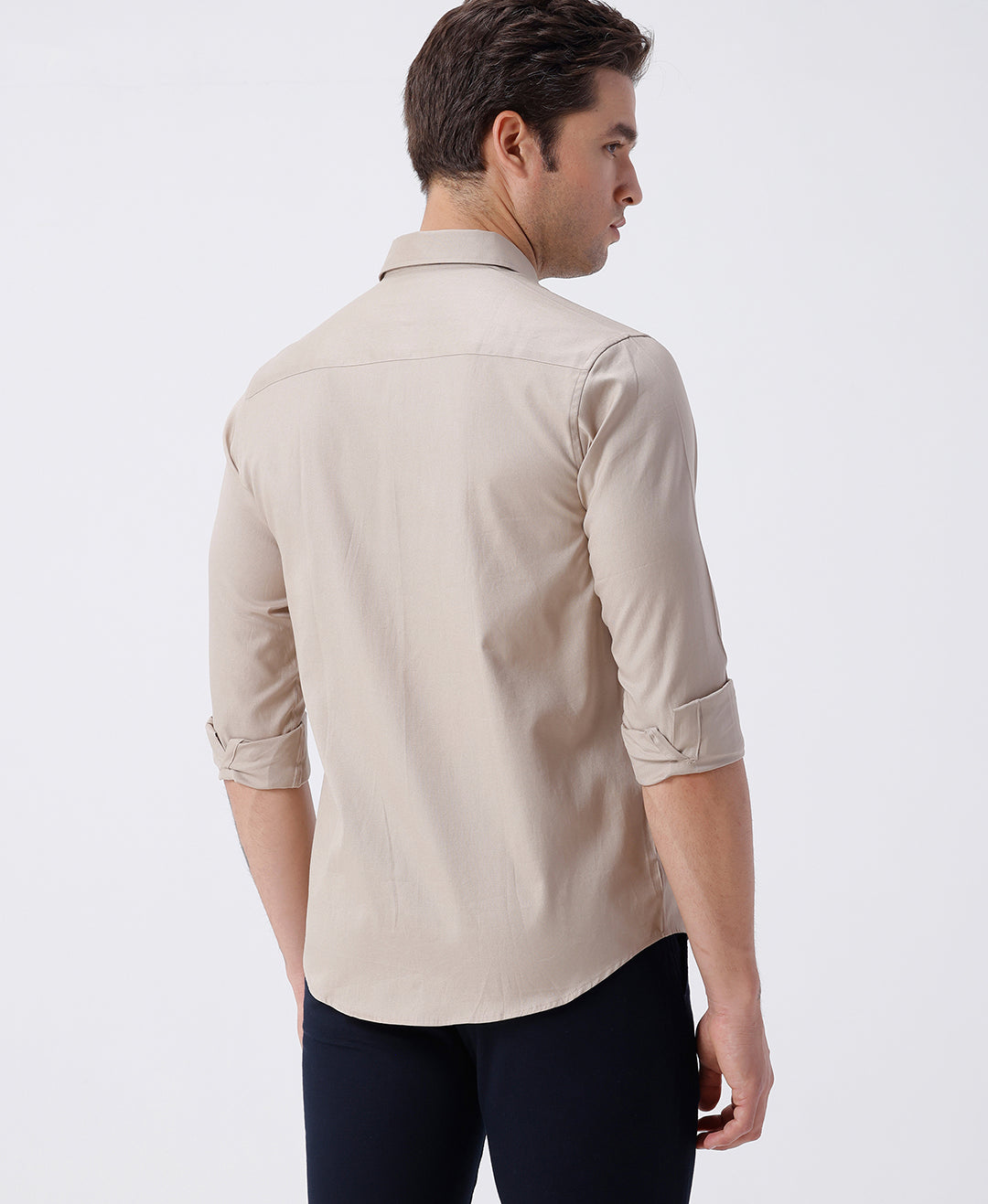 Man wearing a brown smart series premium oxford shirt brown with casual styling on a gray background