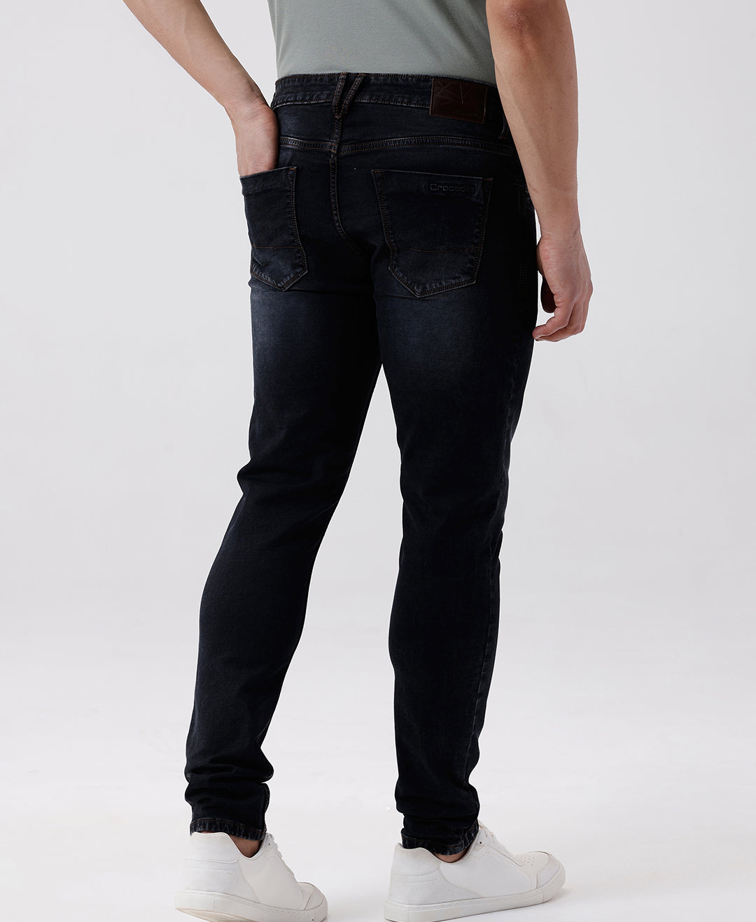 Woman wearing a red natural fade wash red cast denim on a light gray background