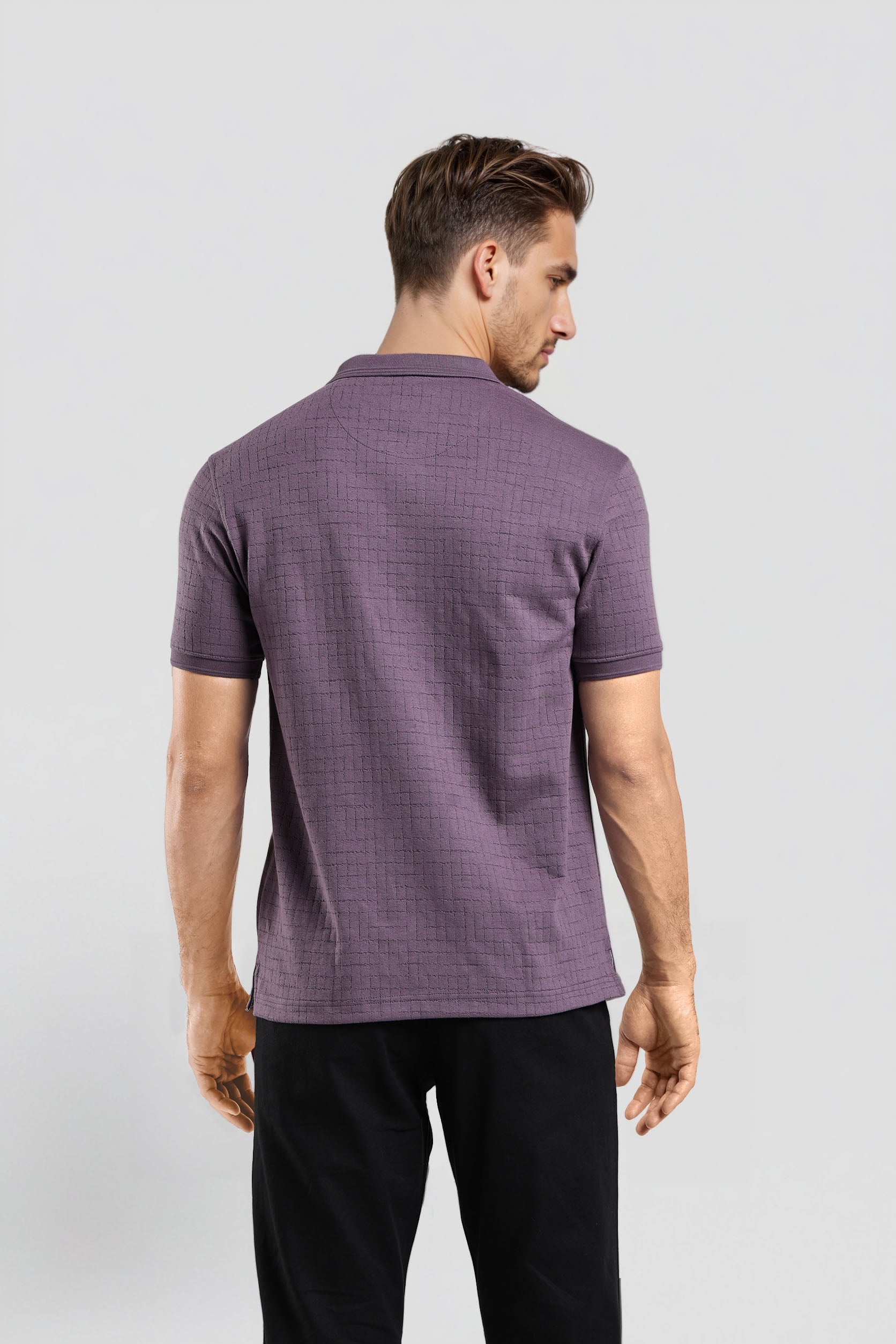 Man wearing a purple checkered polo shirt on a white background