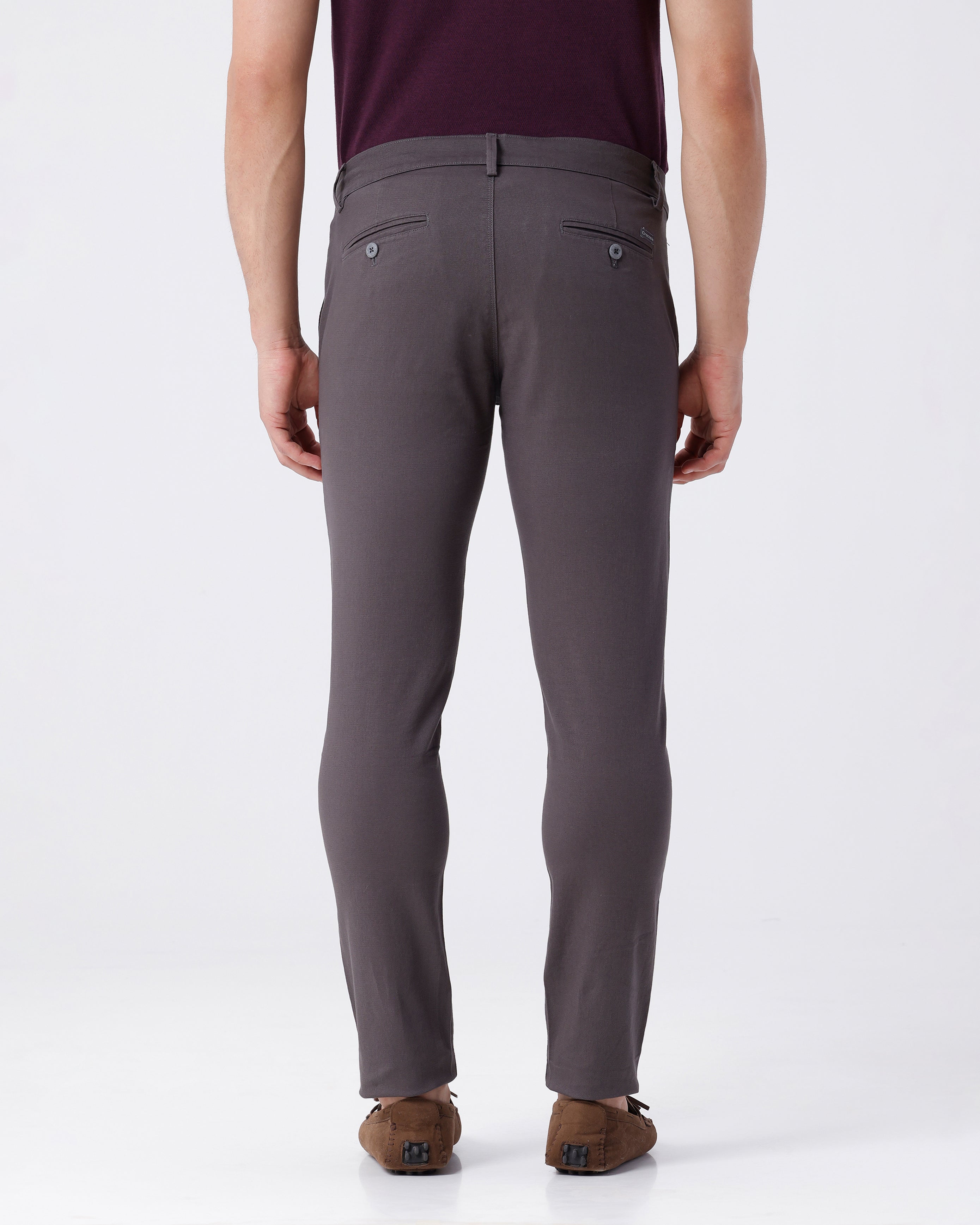 Woman wearing a grey textured essential chinos in dark grey with casual styling on a gray background