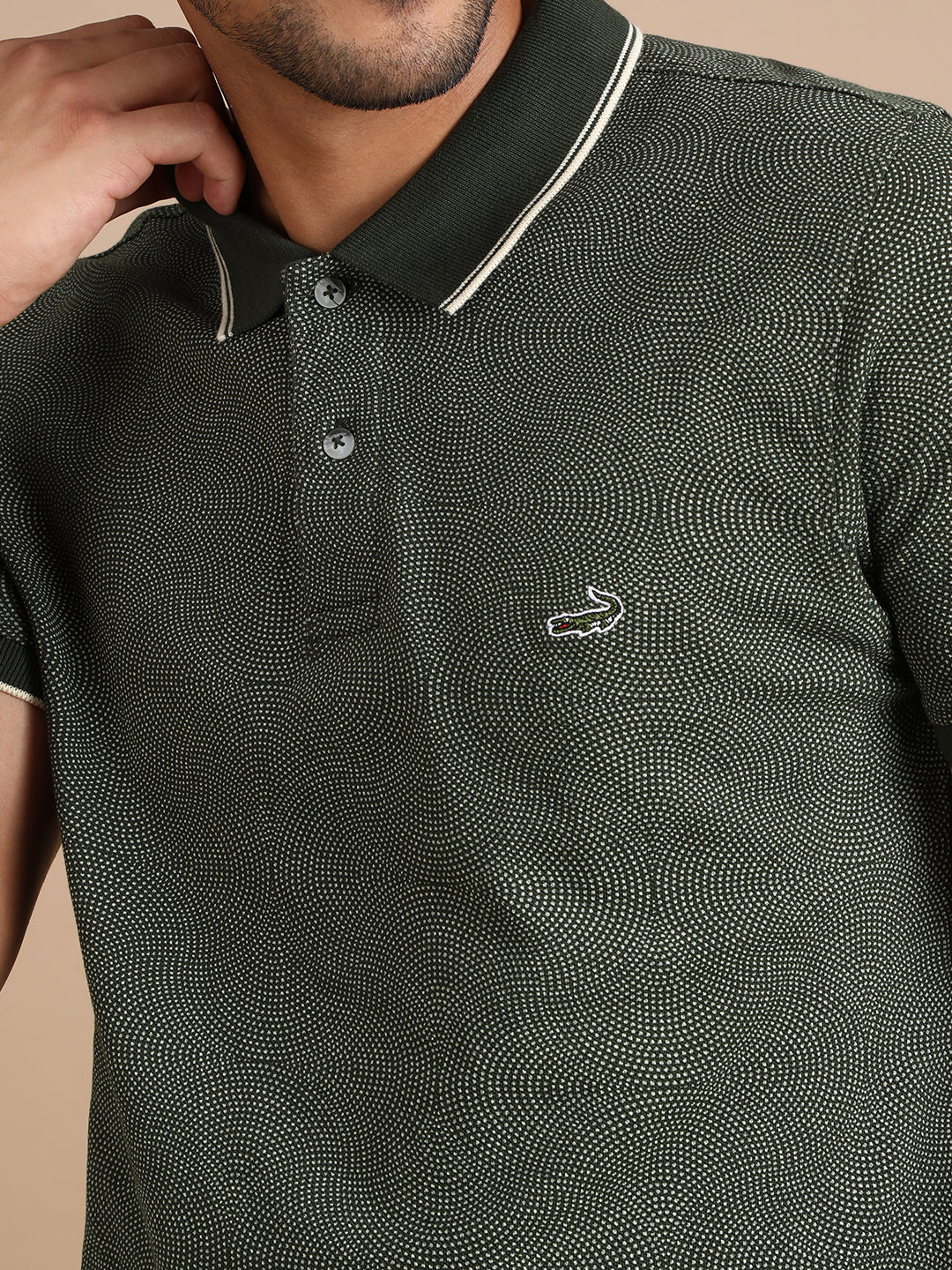Man wearing a green printed kombu green casual polo t shirt with casual styling on a gray background