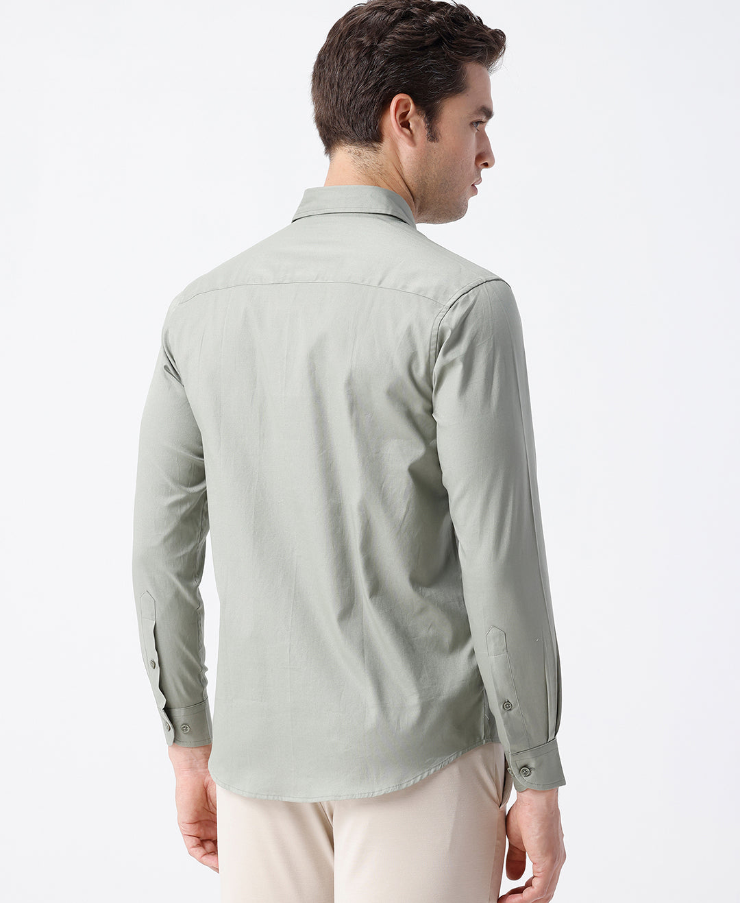 Man wearing a green smart series premium oxford shirt green with casual styling on a gray background