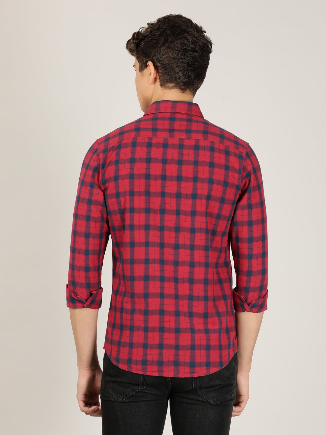 Man wearing a red red checked full sleeve 100% cotton casual shirt on a light gray background