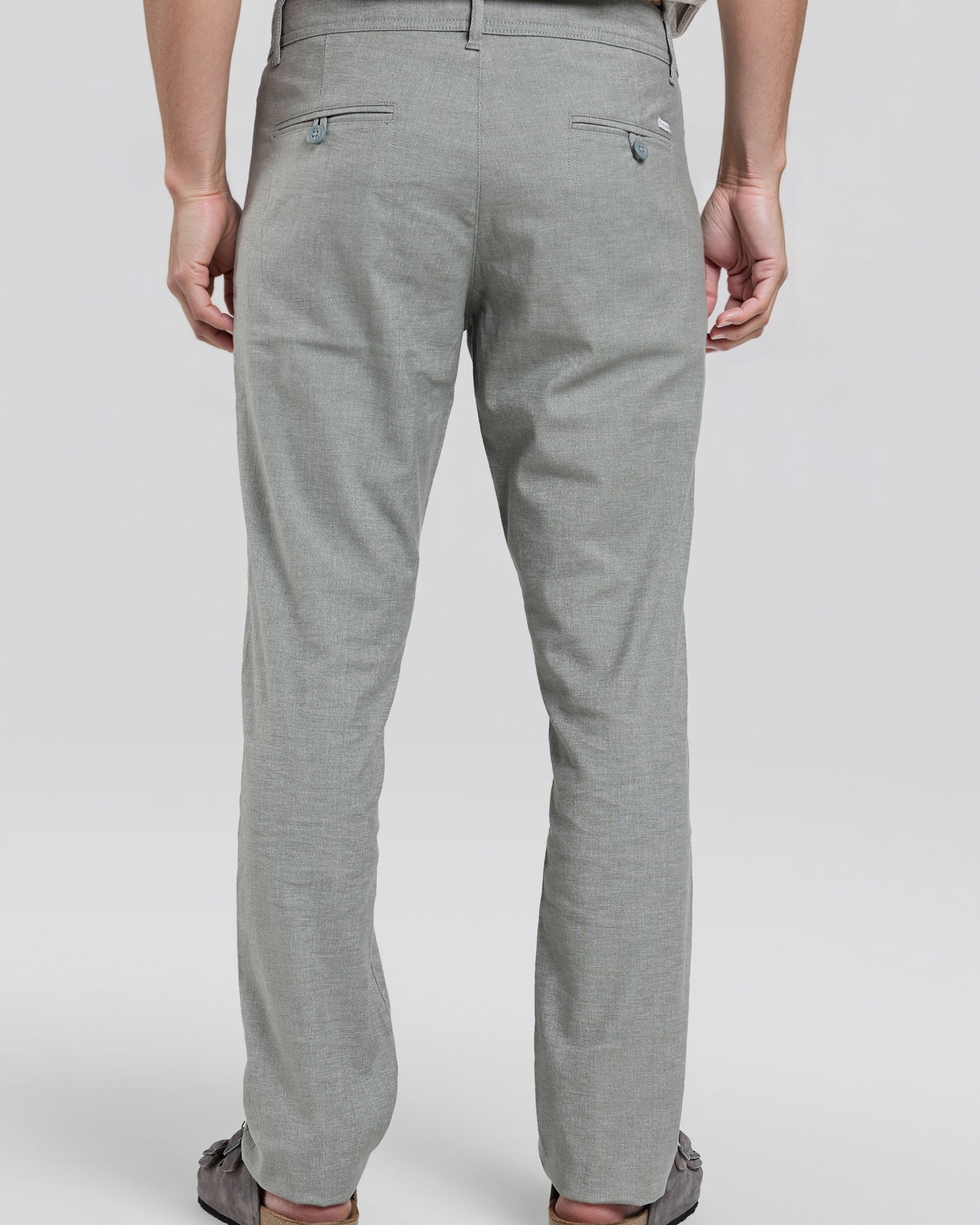 Person wearing gray pants on a white background