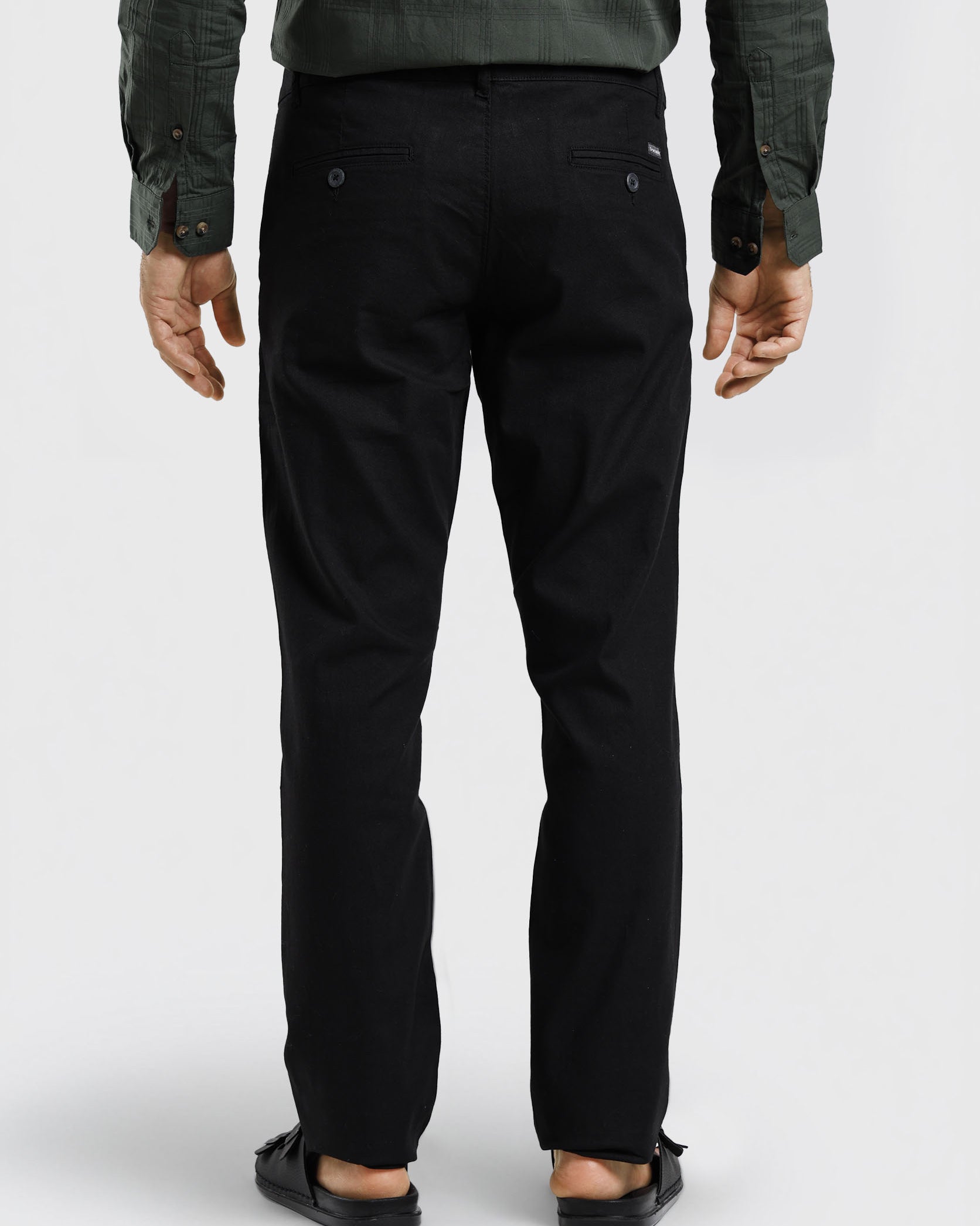 Person wearing black pants on a white background