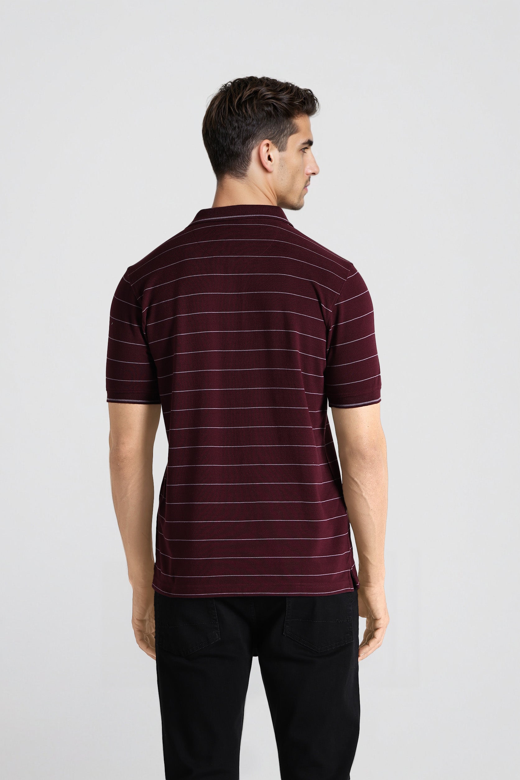 Man wearing a maroon striped polo shirt on a white background