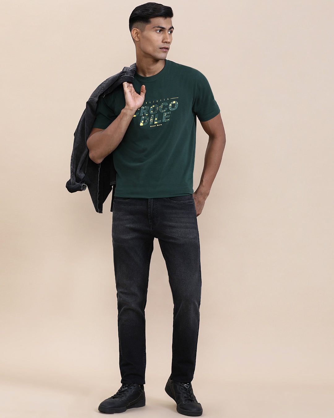 Man wearing a red natural fade wash slim tapered jeans on a light gray background