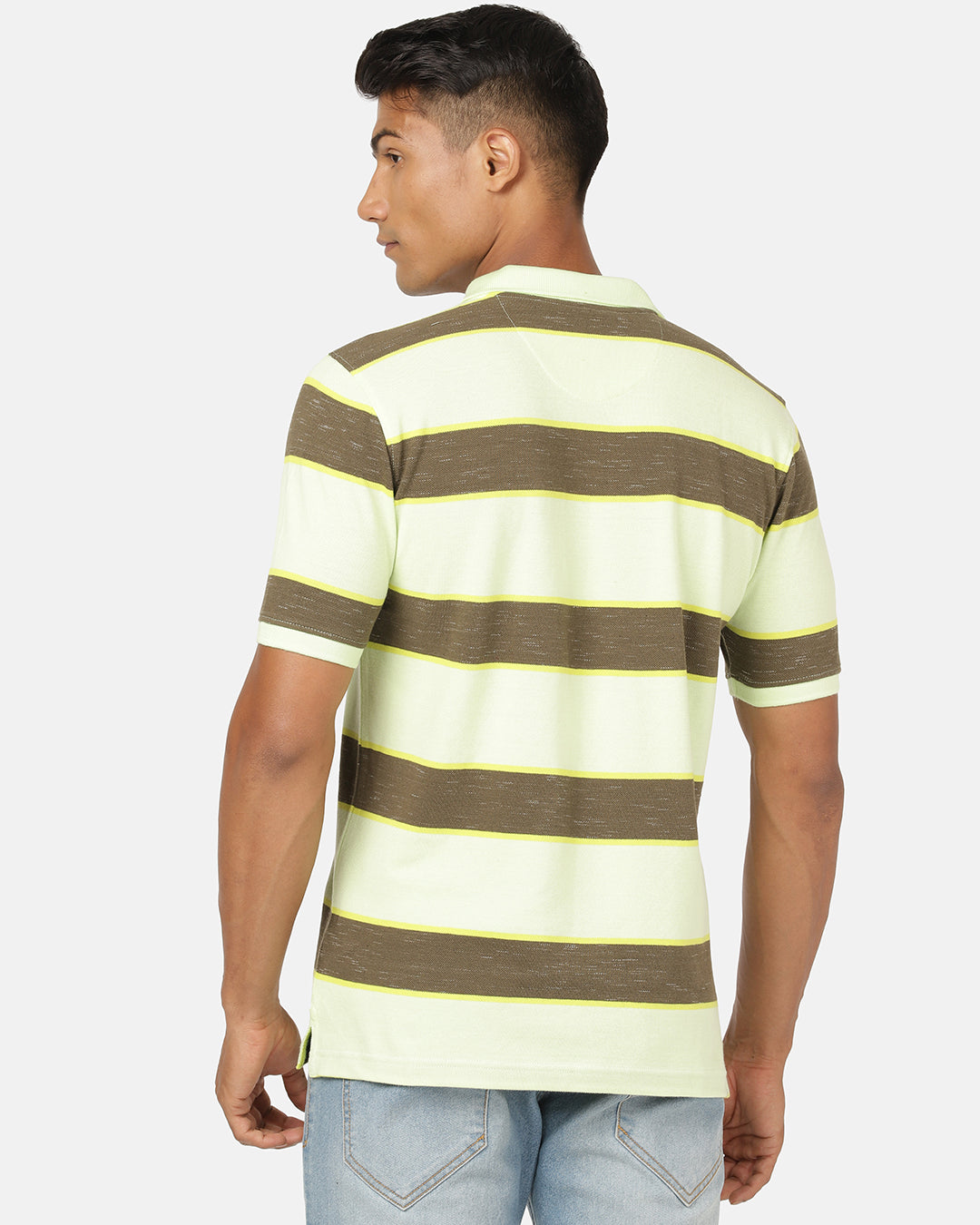 Man wearing a green butterfly green striped polo t shirt with casual styling on a gray background