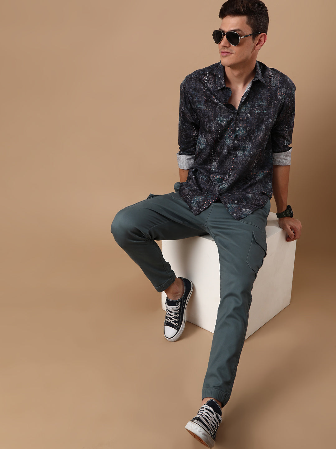 Man wearing a navy printed full sleeve 100% cotton navy casual shirt on a light gray background