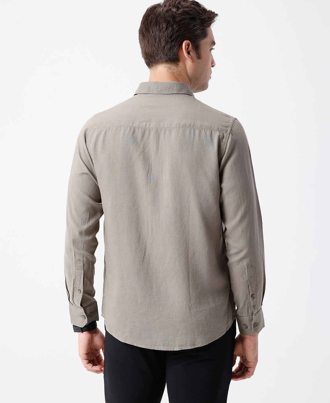 Man wearing a beige linen blend shirt in dark beige on a light gray background