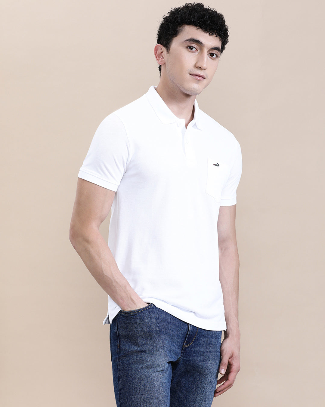 Man wearing a white white solid polo t shirt with pocket with casual styling on a gray background