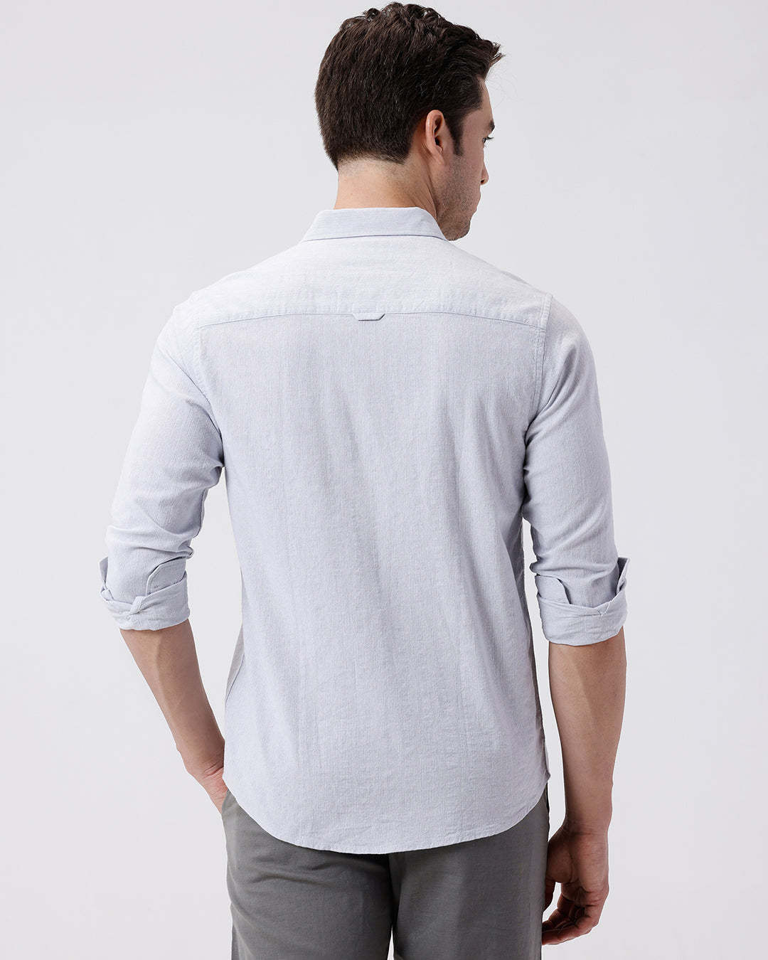 Man wearing a grey rib textured cotton shirt grey on a light gray background