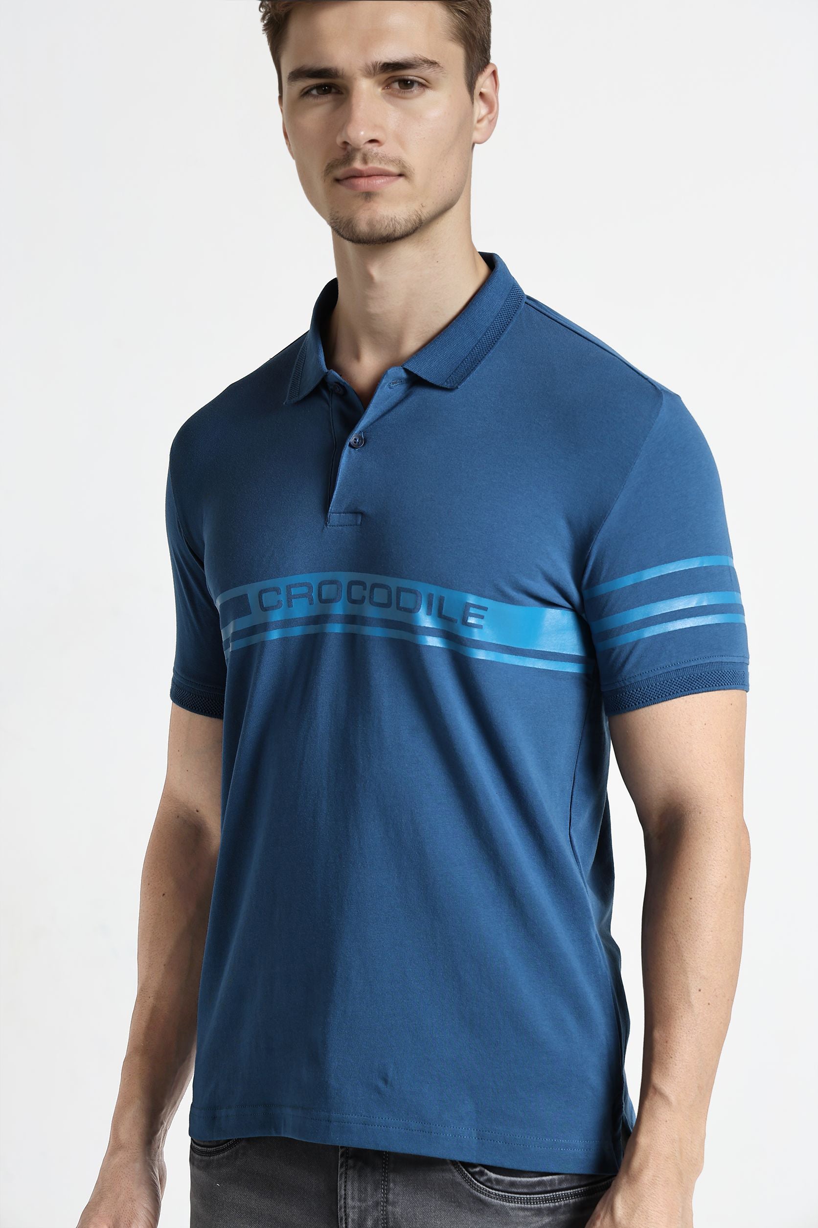 Man wearing a blue polo shirt with a brand logo on a white background