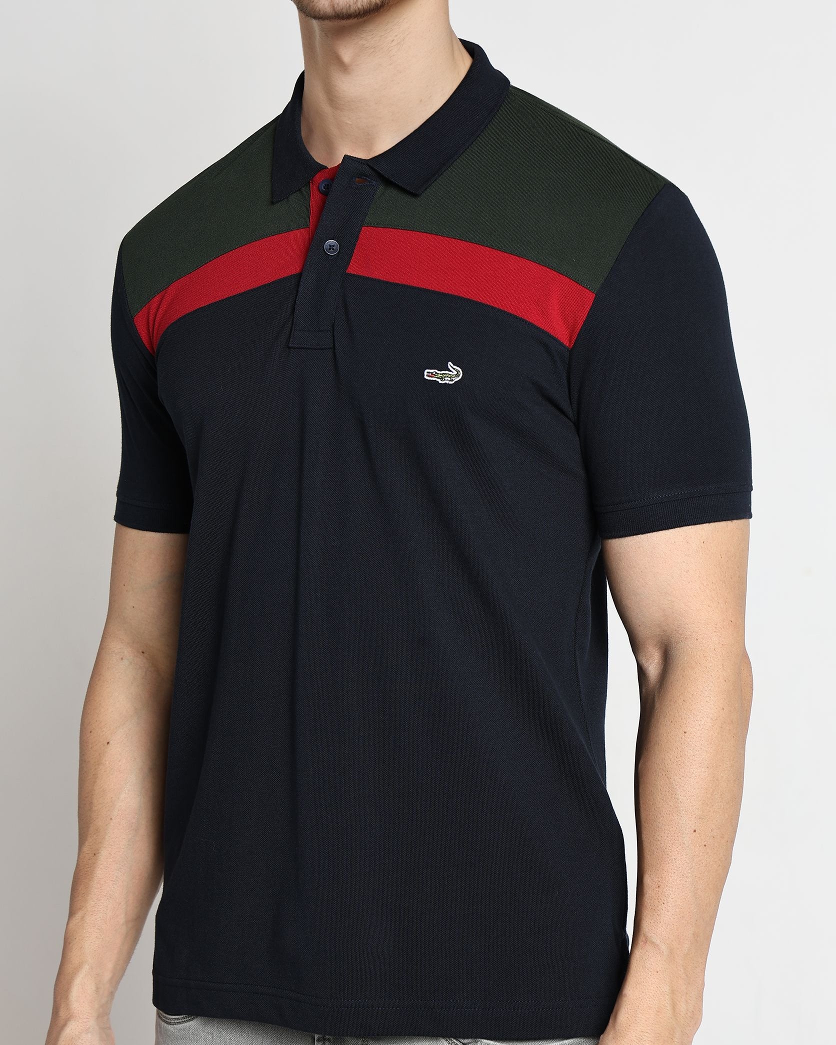 Man wearing a black and red striped polo shirt on a plain background