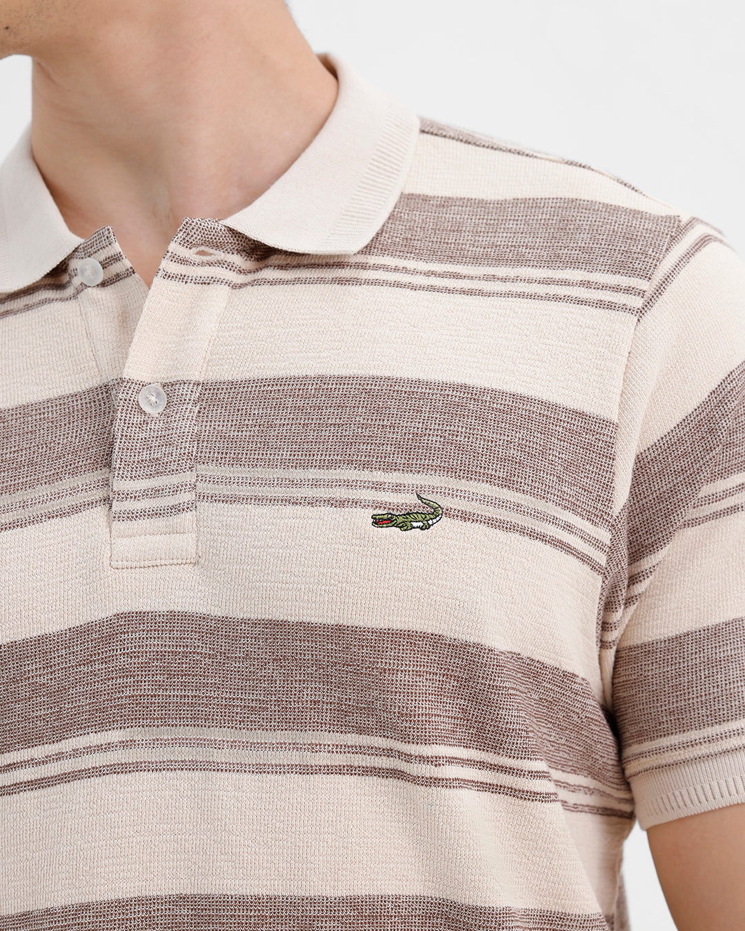 Man wearing a retro classic checked all over printed polo t shirt with casual styling on a gray background