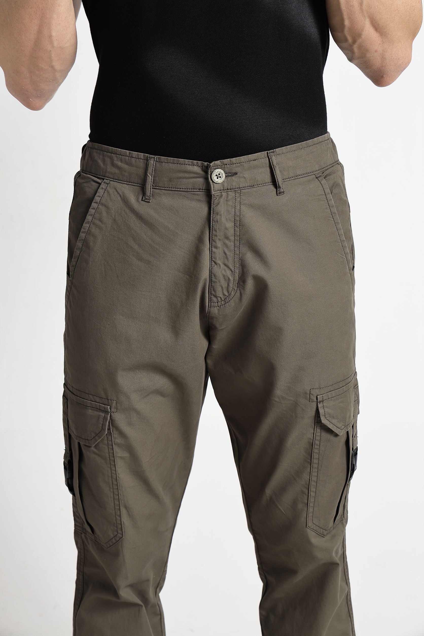 Brown cargo pants worn by a person on a white background