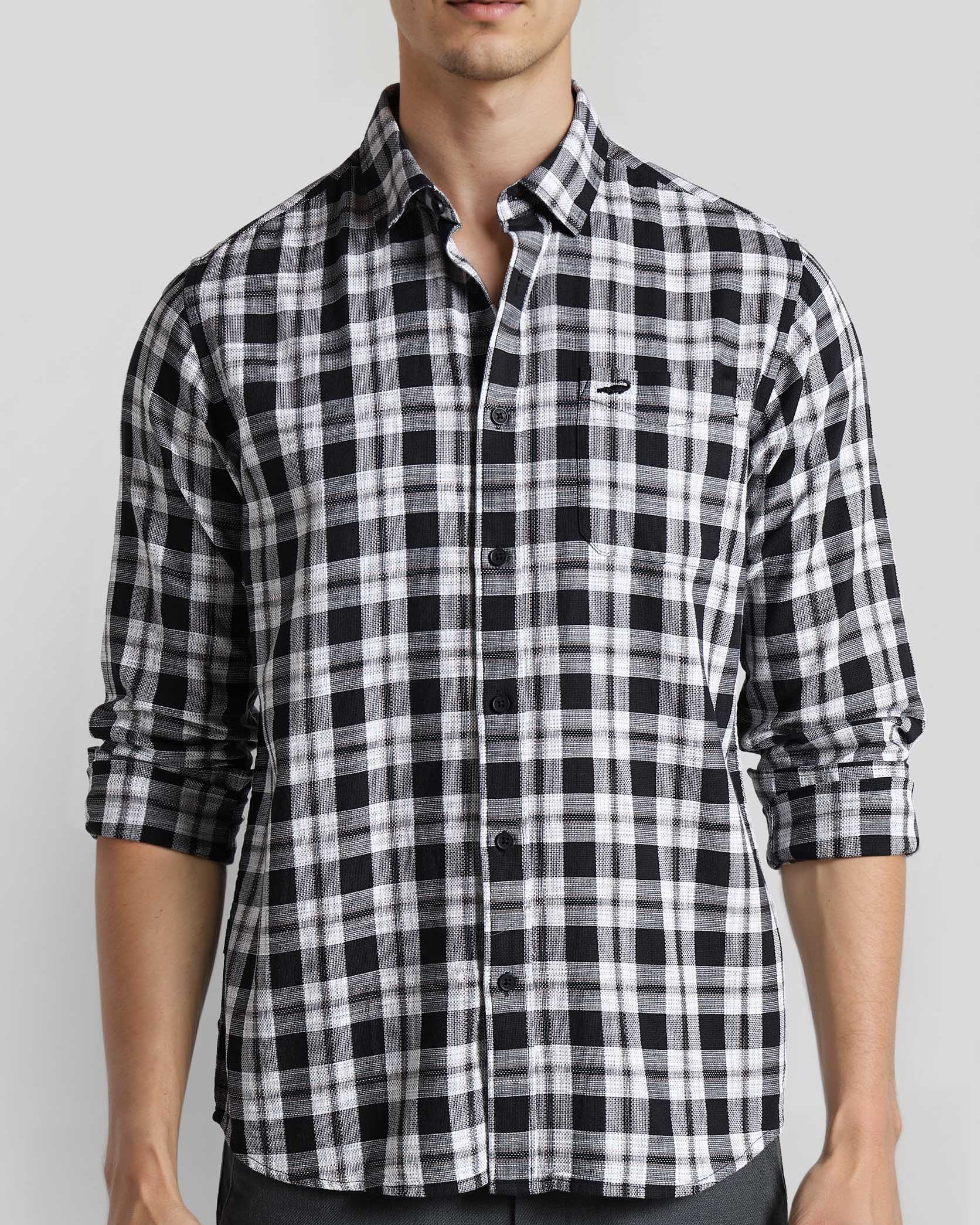 Man wearing a black and white checkered shirt on a light gray background