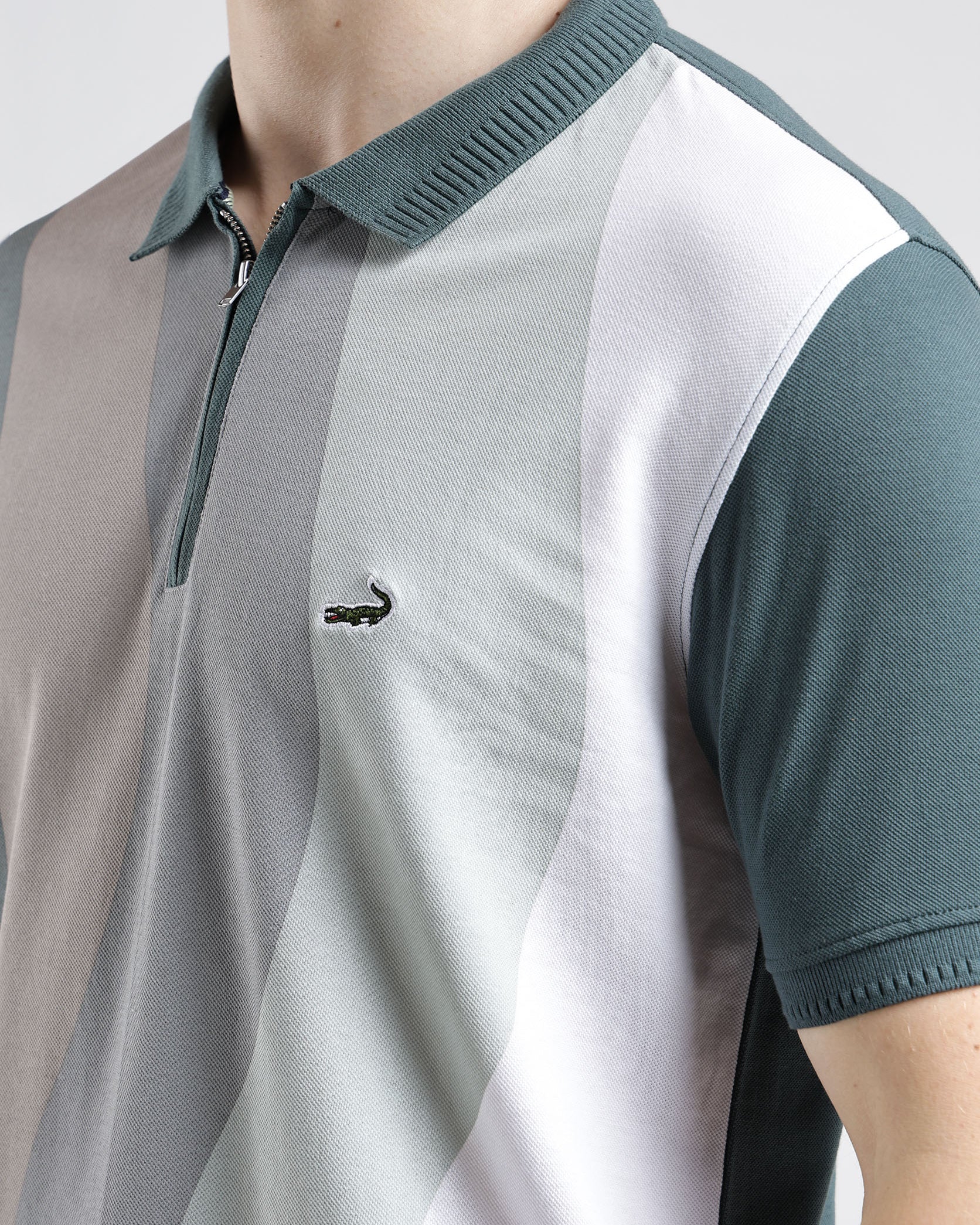 Color-blocked polo shirt with a brand logo on a neutral background