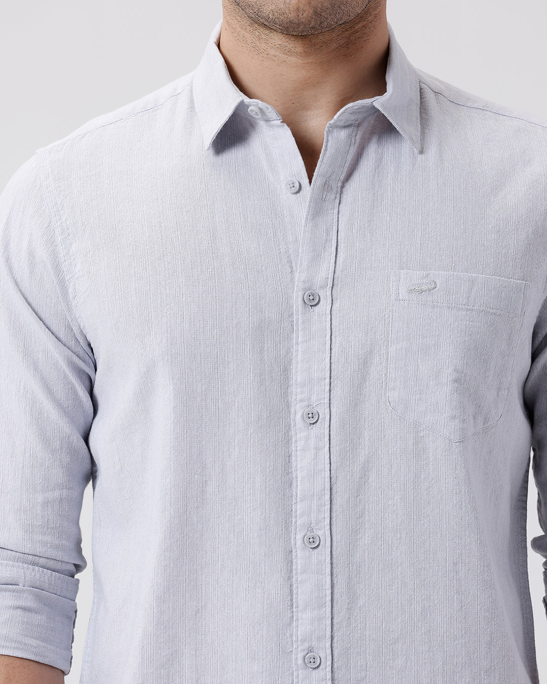 Man wearing a grey rib textured cotton shirt grey on a light gray background