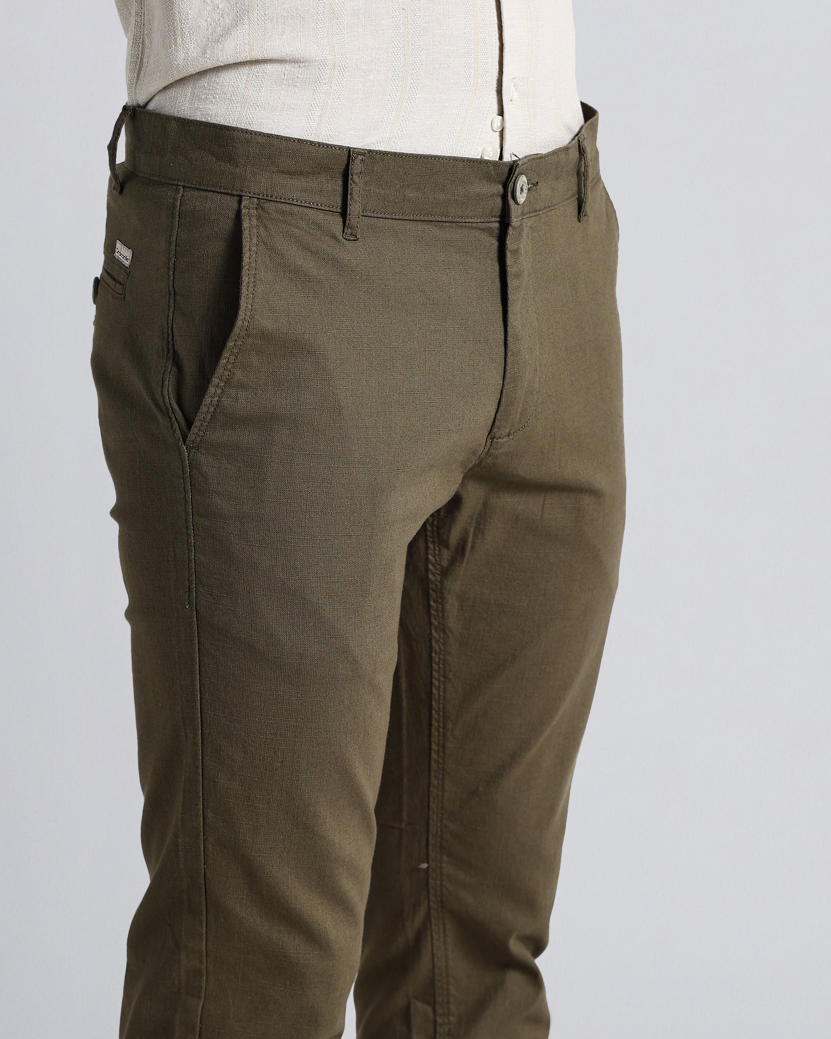 Brown pants worn by a person on a light gray background