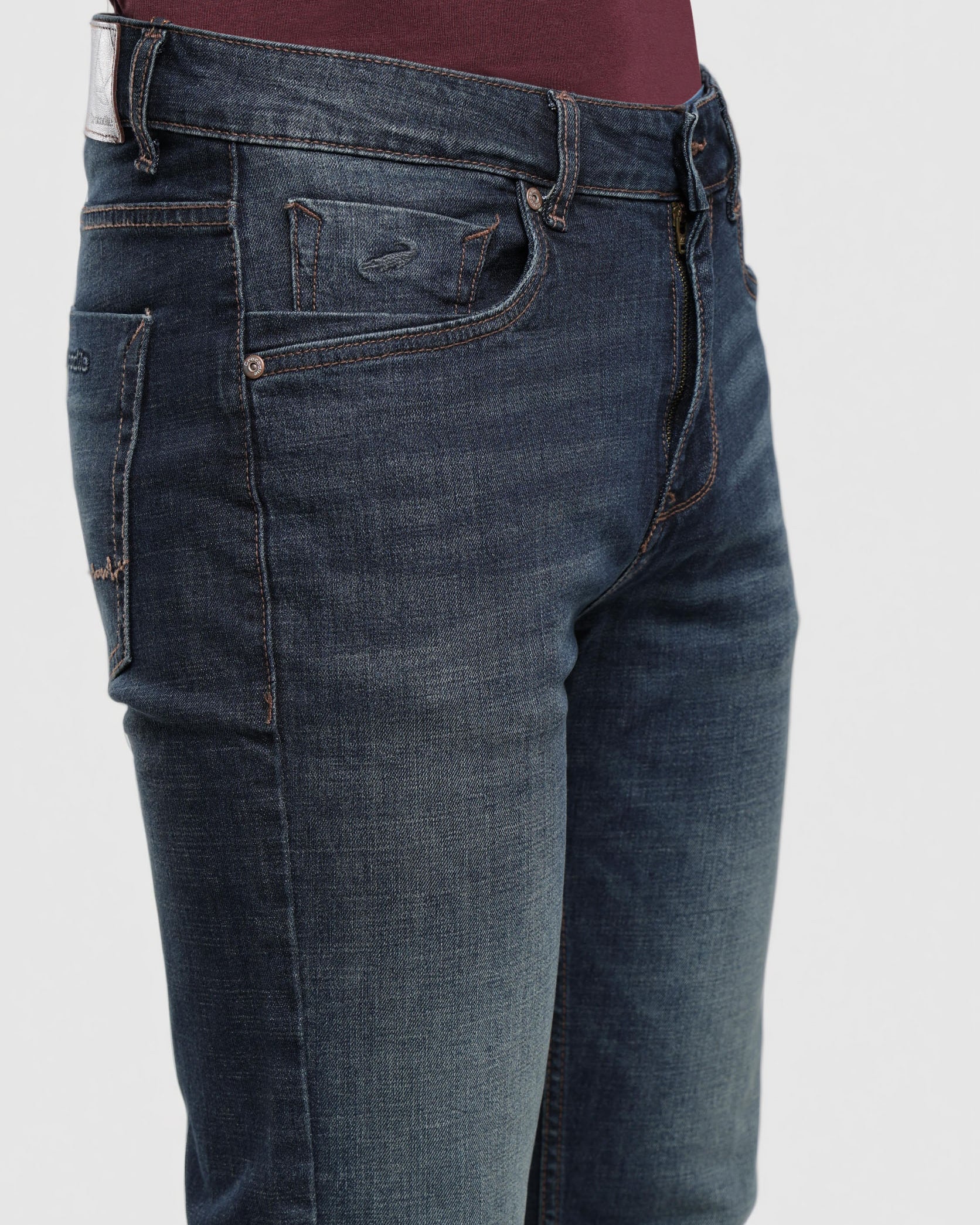 Blue jeans worn by a person on a white background