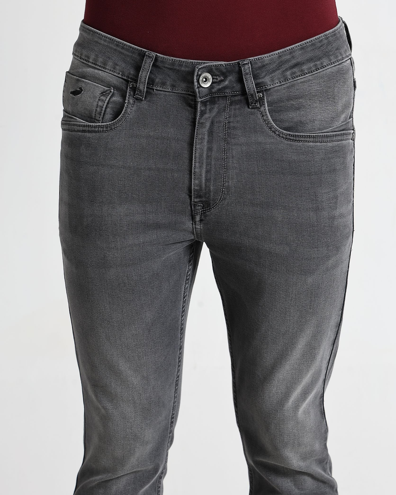 Gray jeans worn by a person on a white background