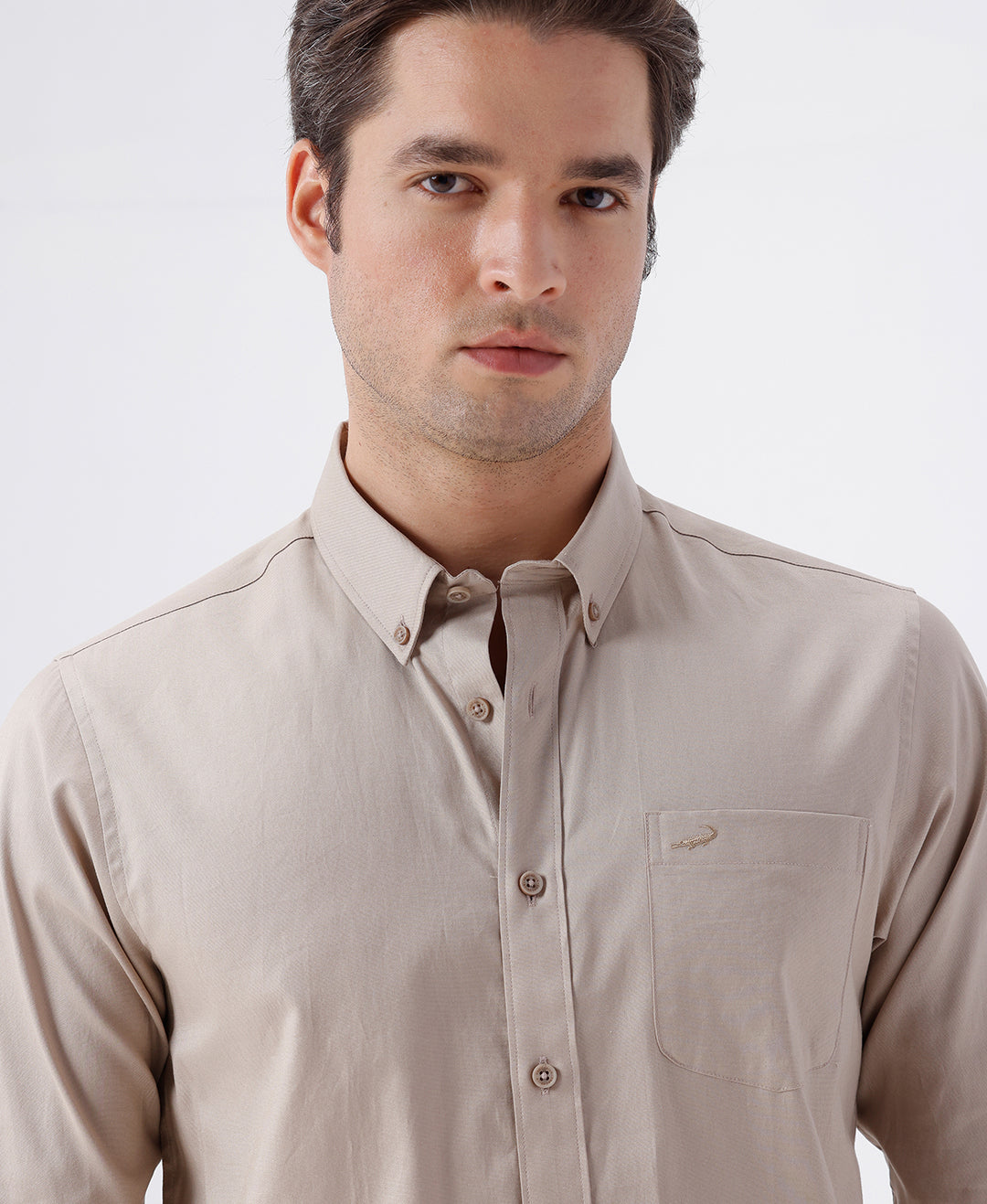 Man wearing a brown smart series premium oxford shirt brown with casual styling on a gray background
