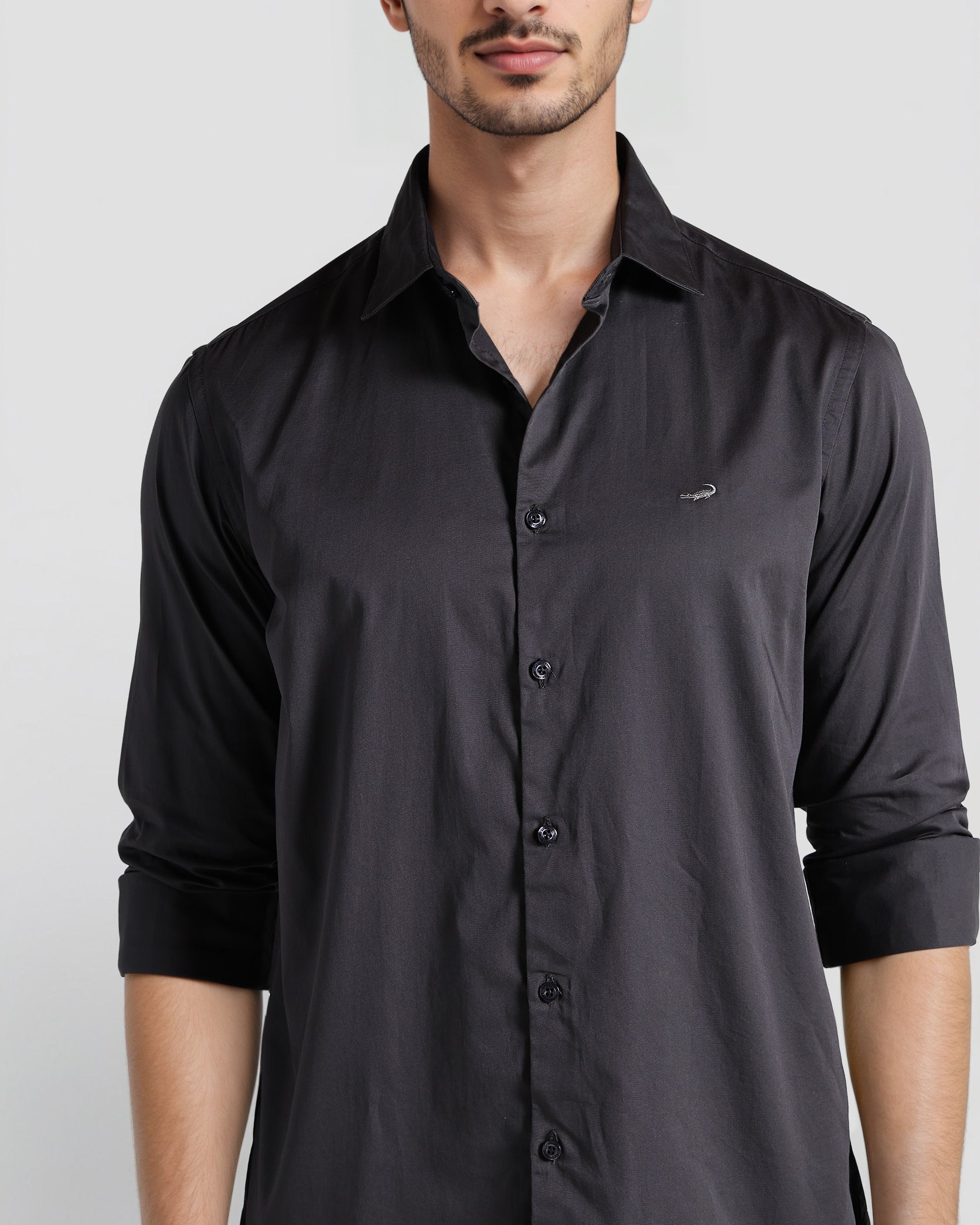 Man wearing a black shirt against a white background