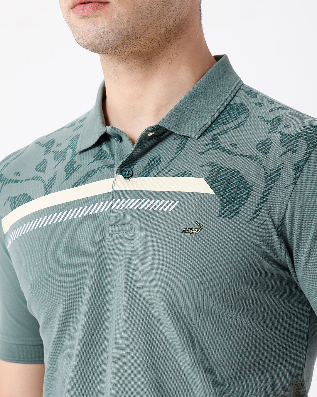 Man wearing a green iceberg green chest print slim fit polo t shirt on a light gray background