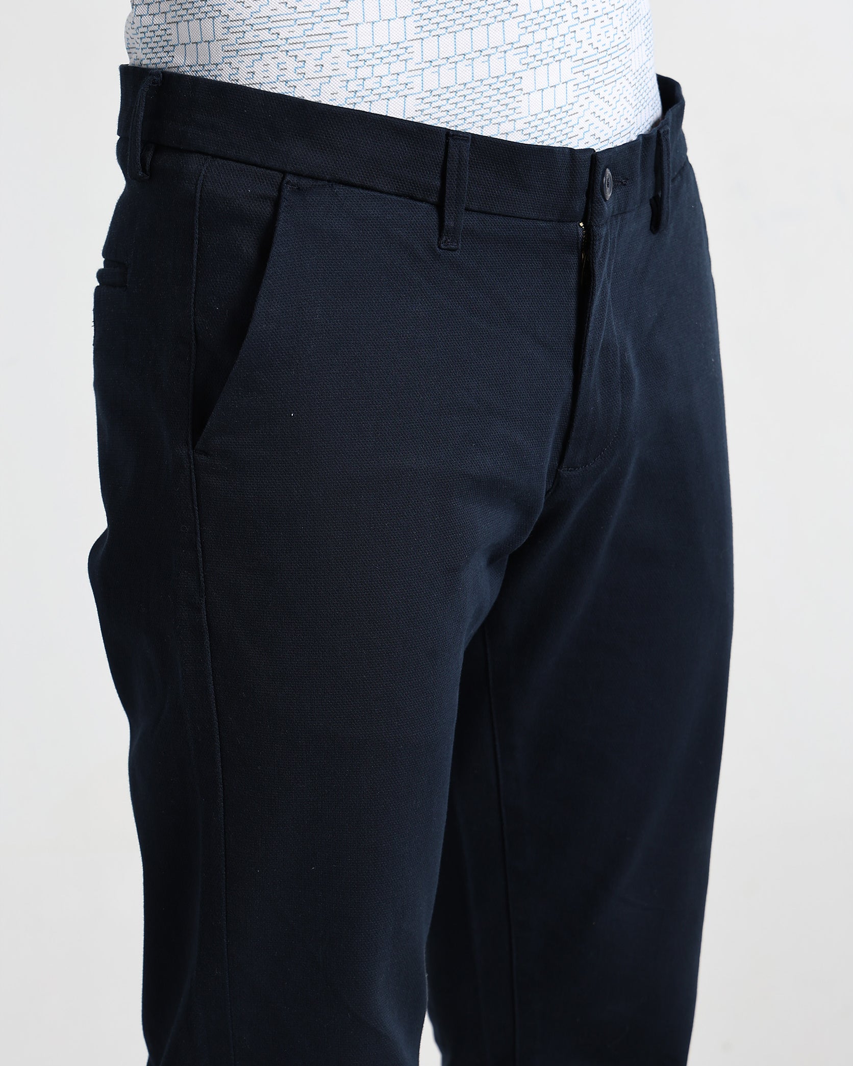 Black pants worn by a person on a white background