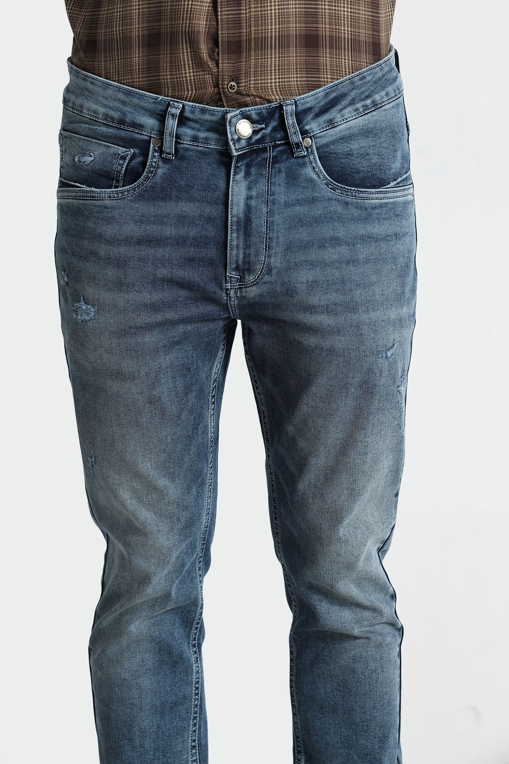 Blue jeans worn by a person on a white background