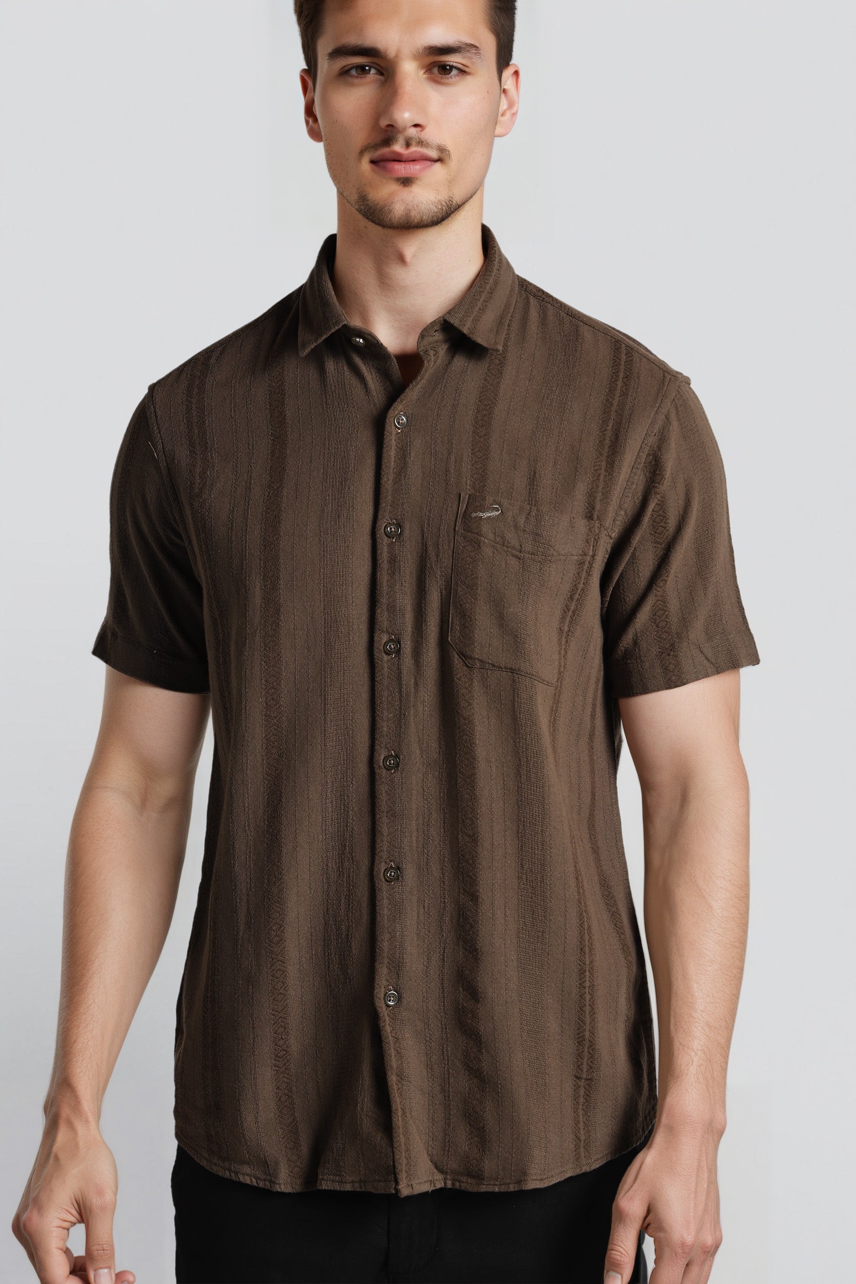 Man wearing a brown short-sleeve shirt against a white background