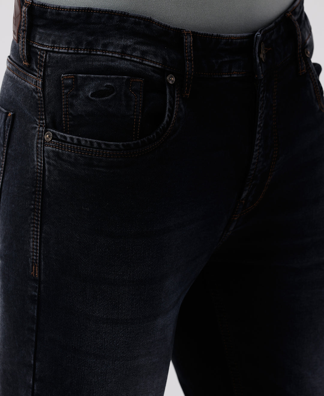 Woman wearing a red natural fade wash red cast denim on a light gray background