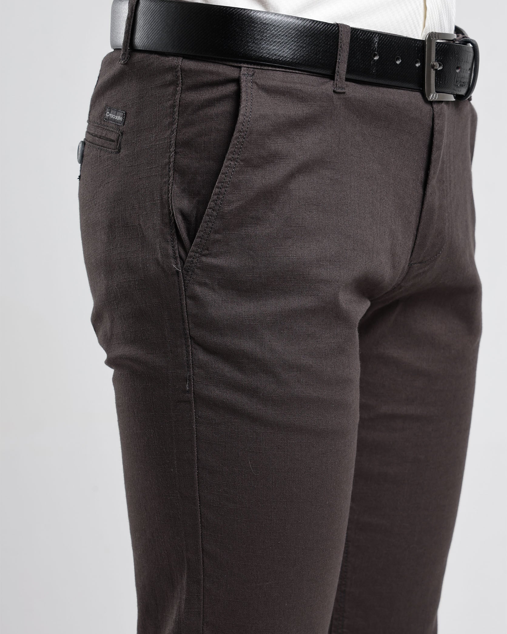 Brown pants with a black belt on a white background