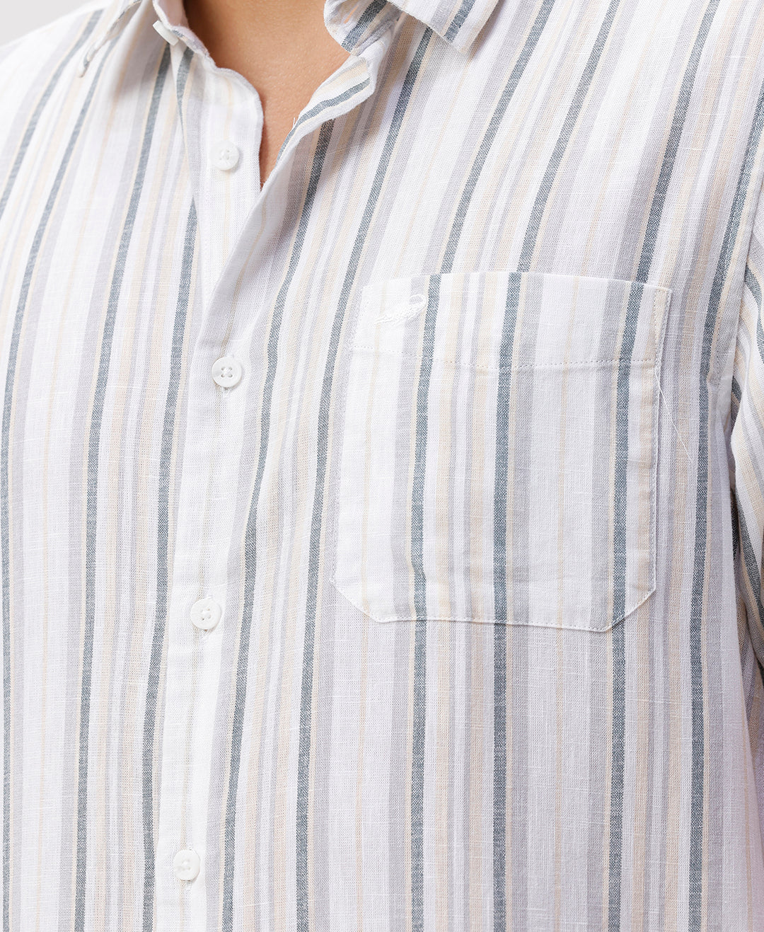 Man wearing a white white and green stripes comfort fit casuals shirts on a light gray background