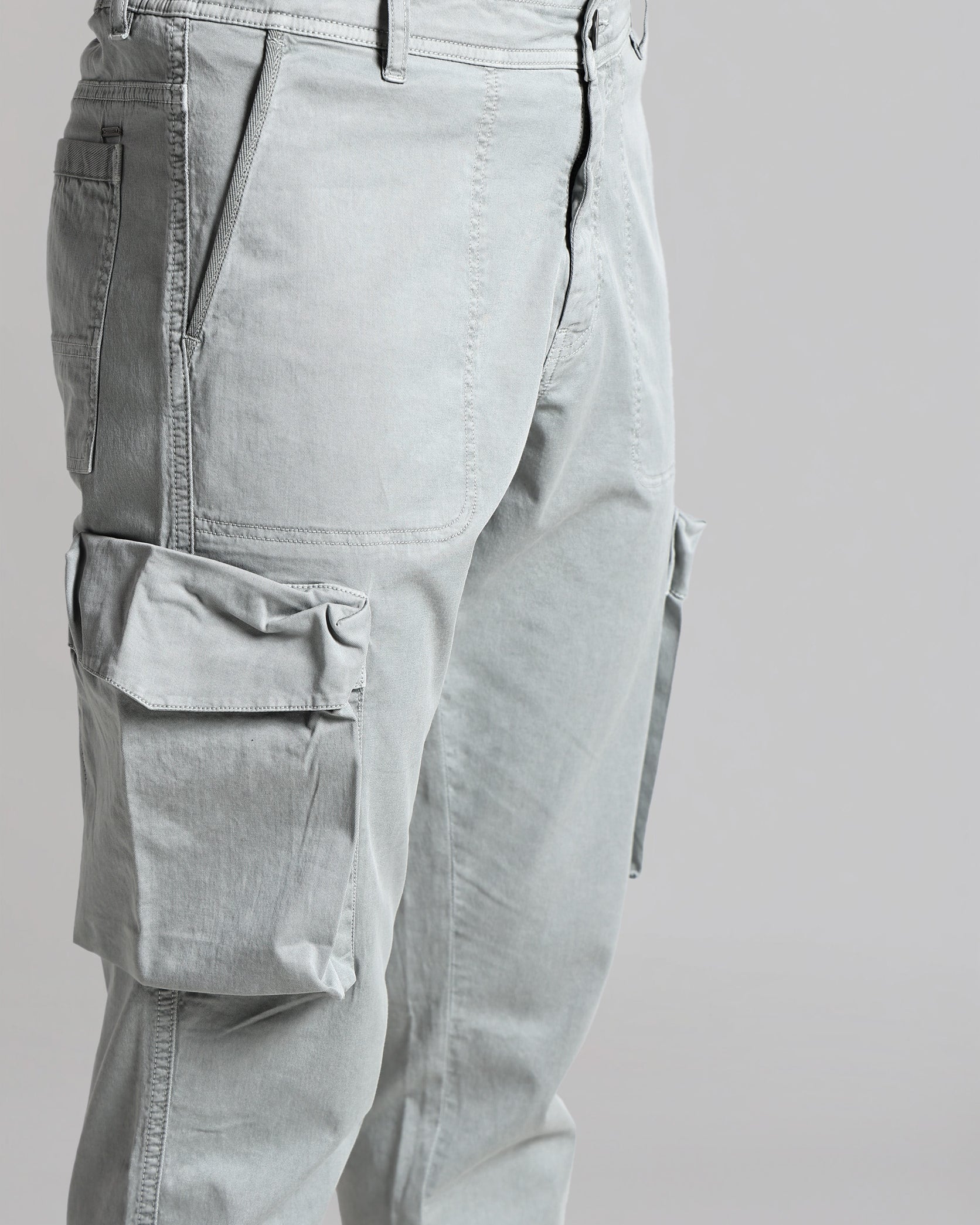 Light gray cargo pants on a plain background