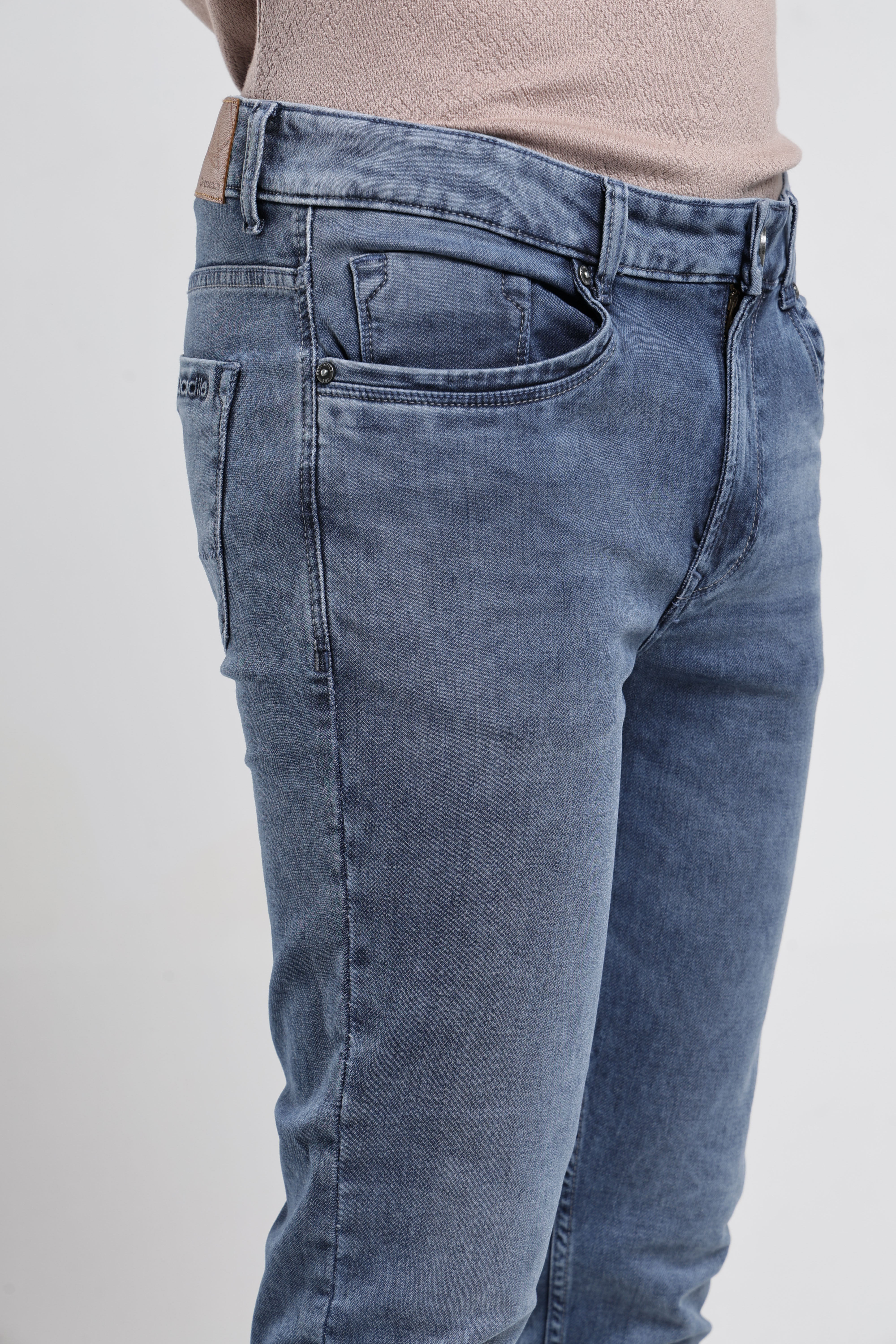 Blue jeans worn by a person on a white background