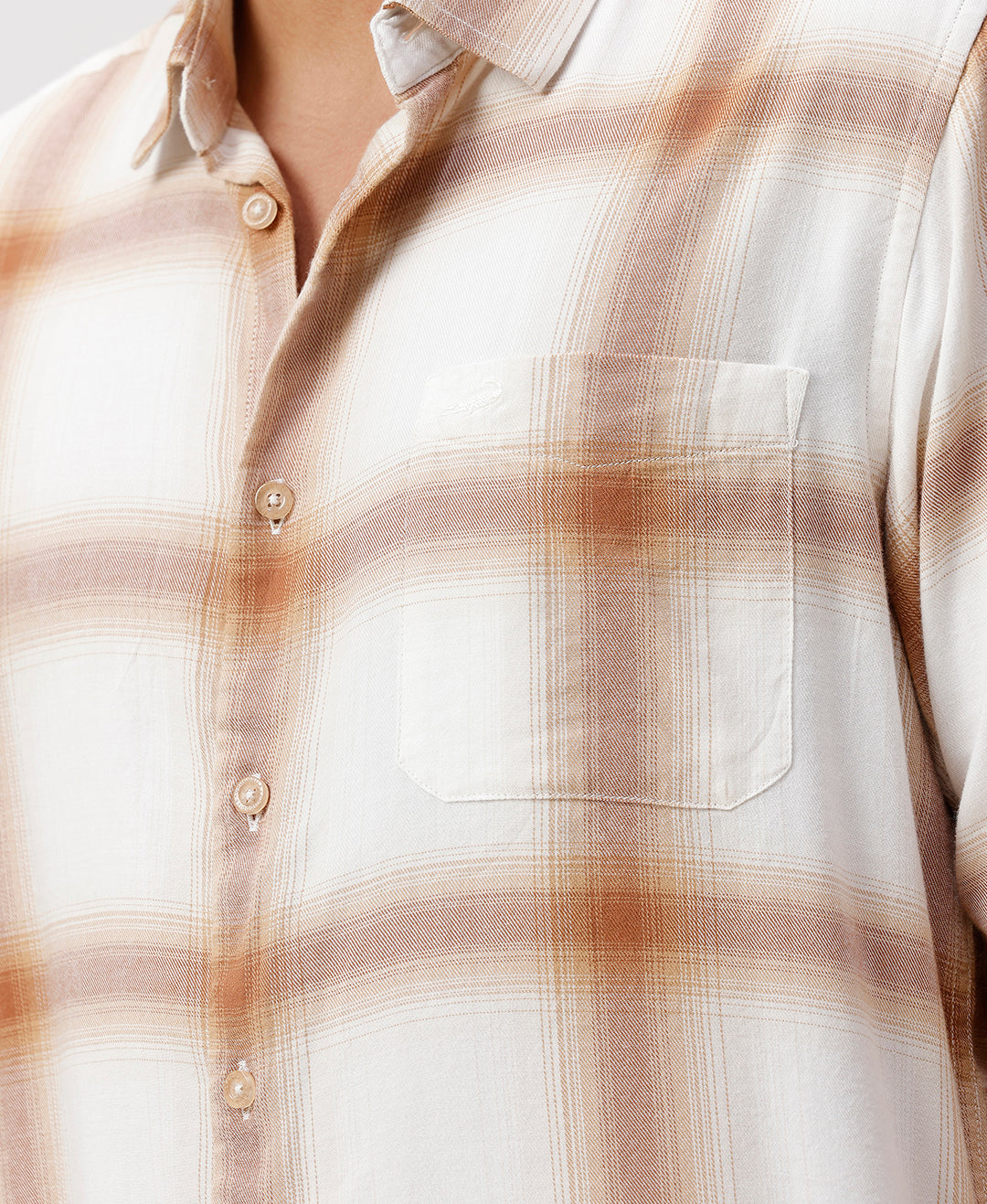 Man wearing a red textured grunge print shirt with casual styling on a gray background