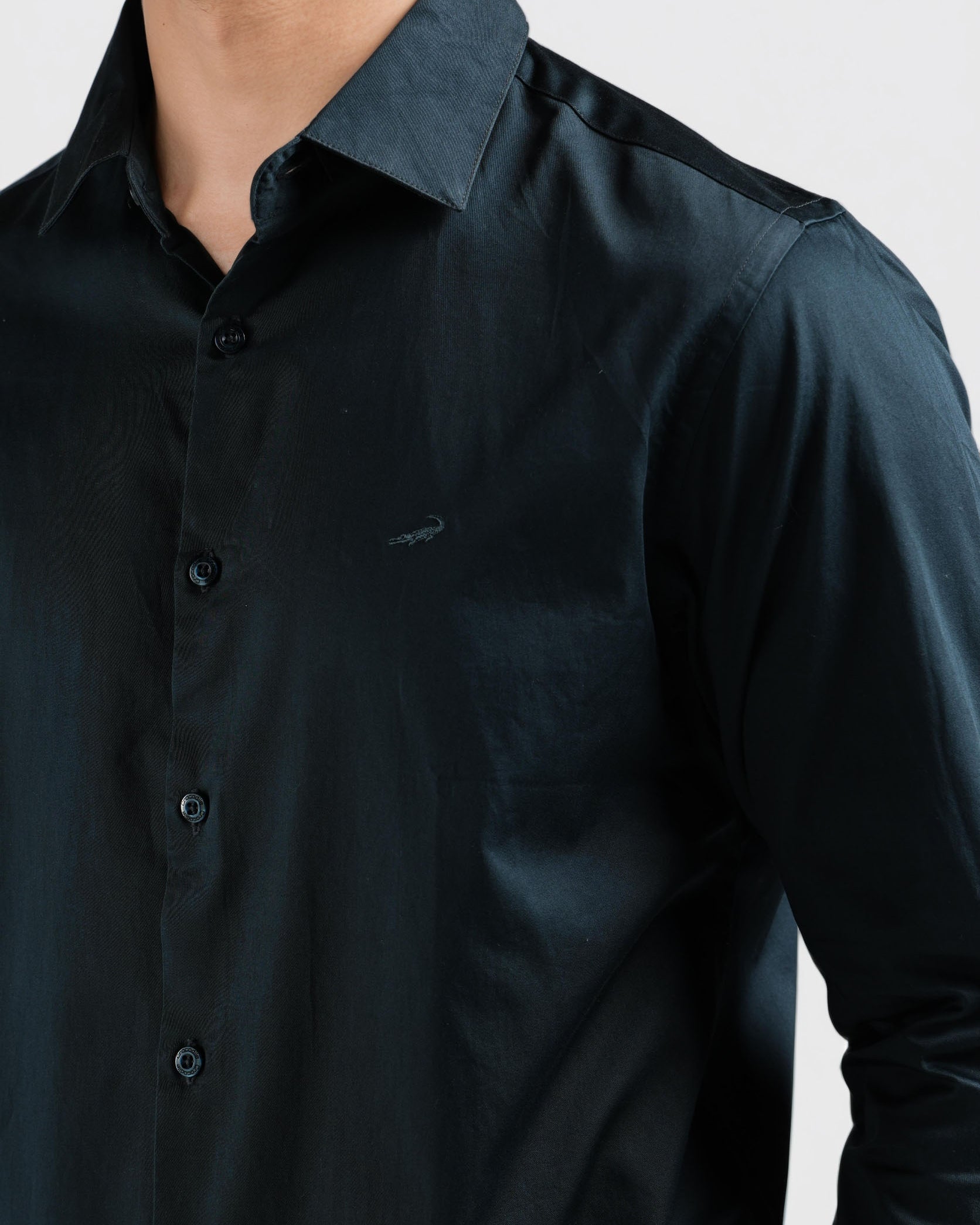 Black shirt worn by a person on a light gray background
