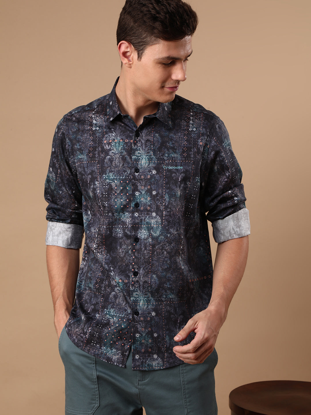 Man wearing a navy printed full sleeve 100% cotton navy casual shirt on a light gray background