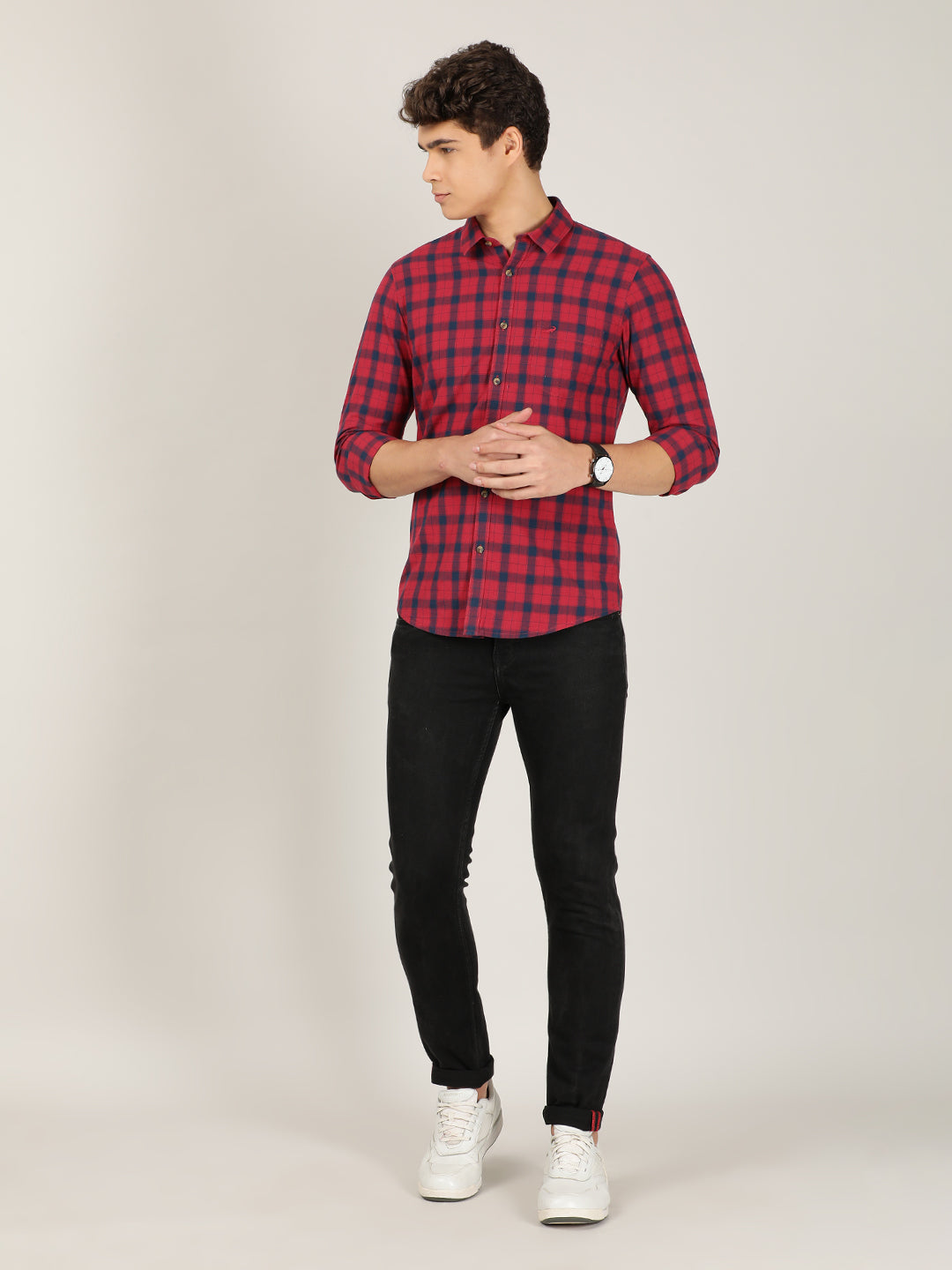 Man wearing a red red checked full sleeve 100% cotton casual shirt on a light gray background