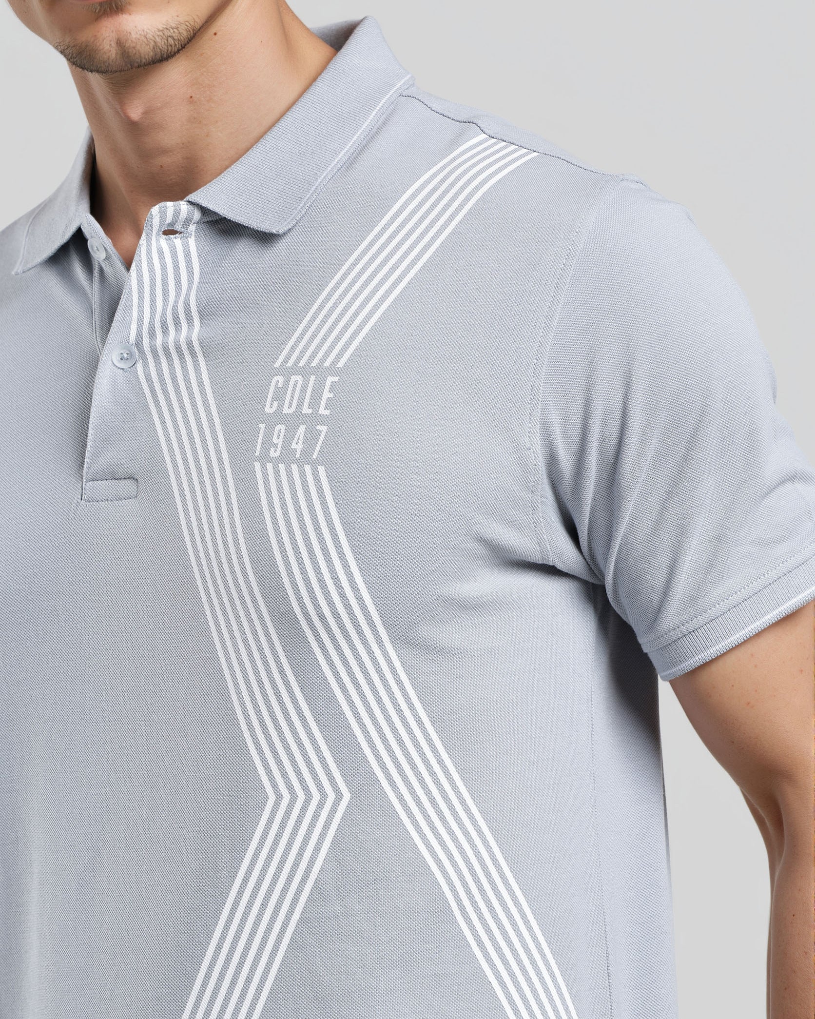Gray polo shirt with white stripes and 'Cole 1847' branding on a plain background