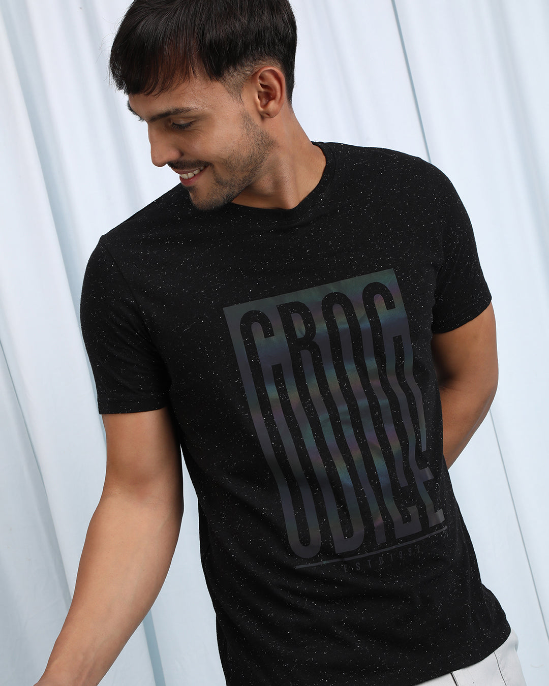 Man wearing a brown brown casual printed t shirt with casual styling on a gray background