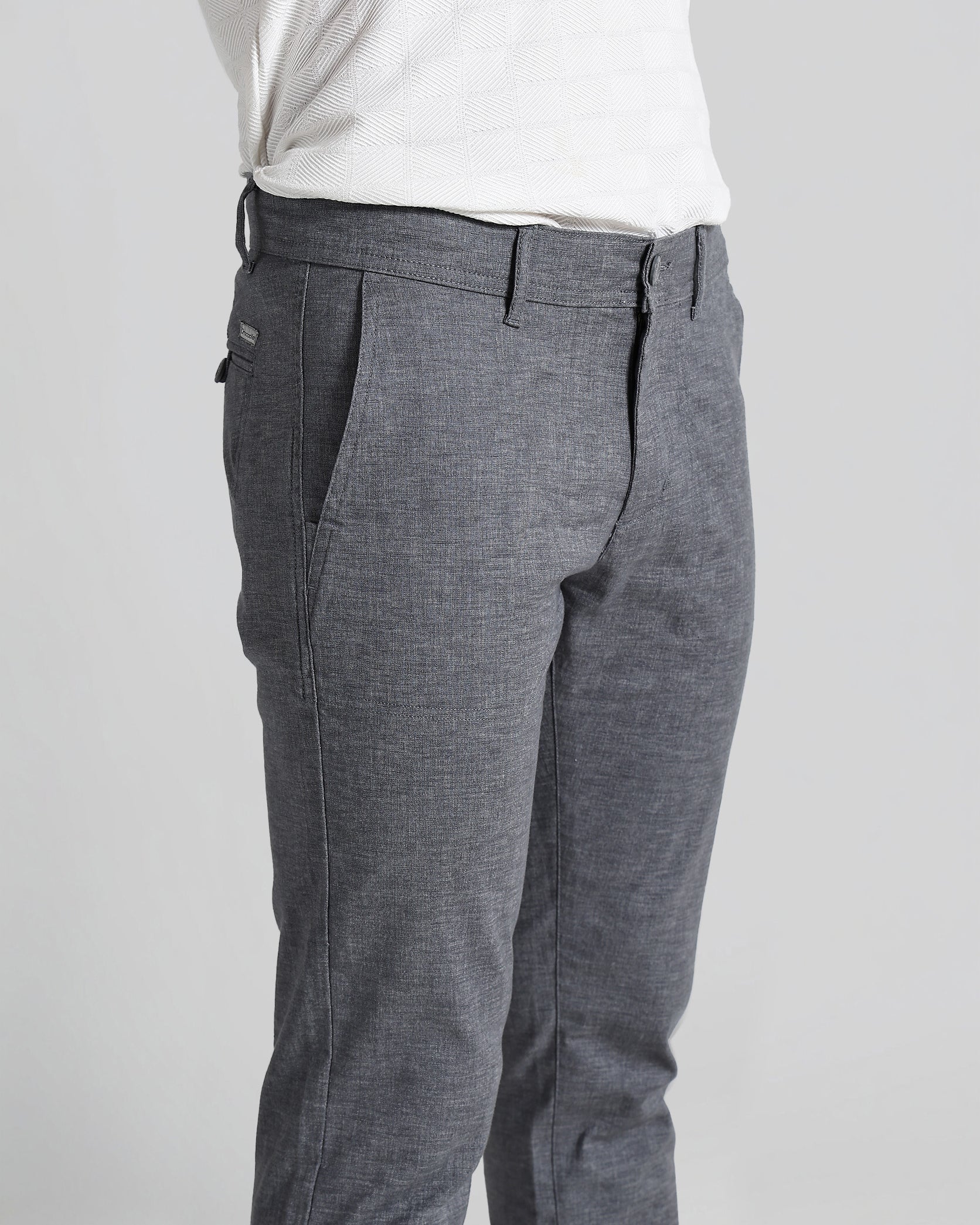 Gray pants worn by a person on a plain background