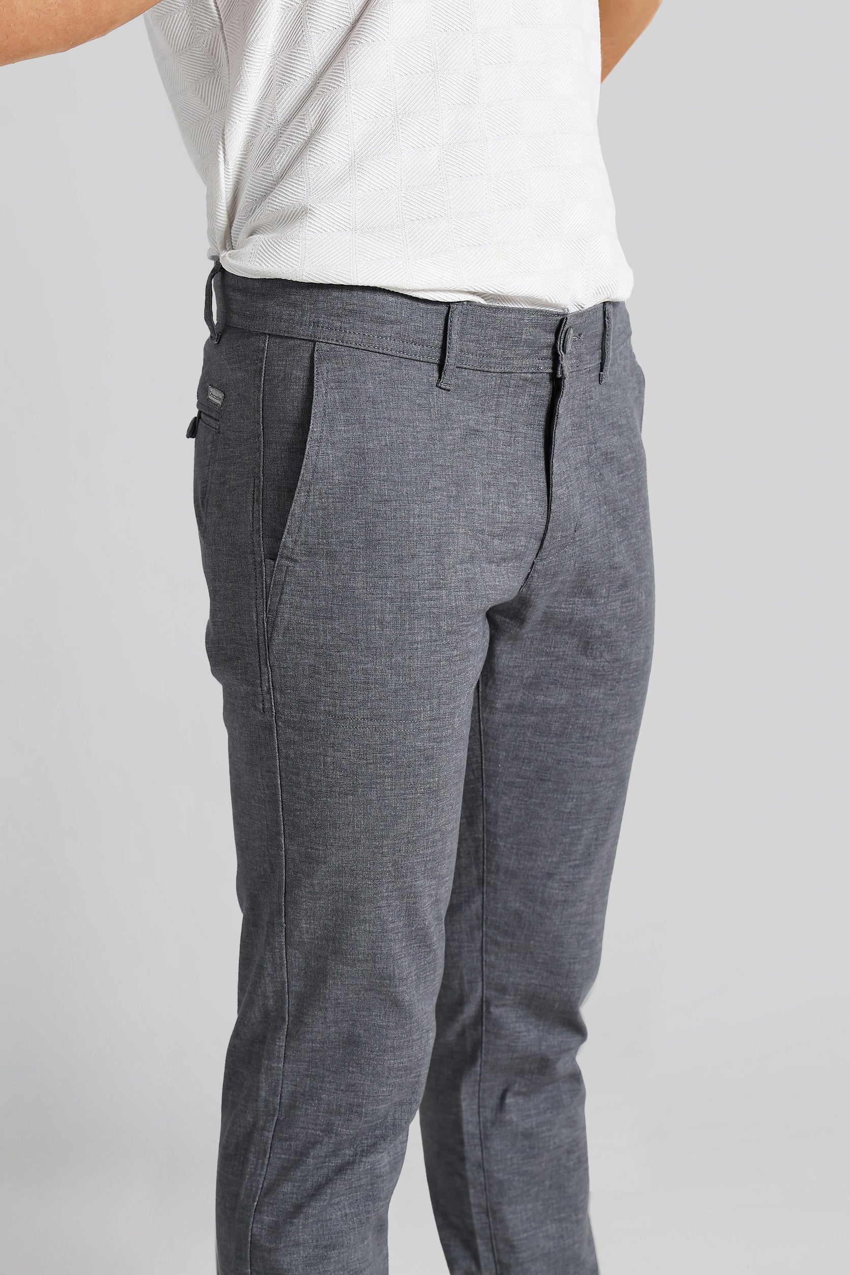 Gray pants worn by a person on a plain background
